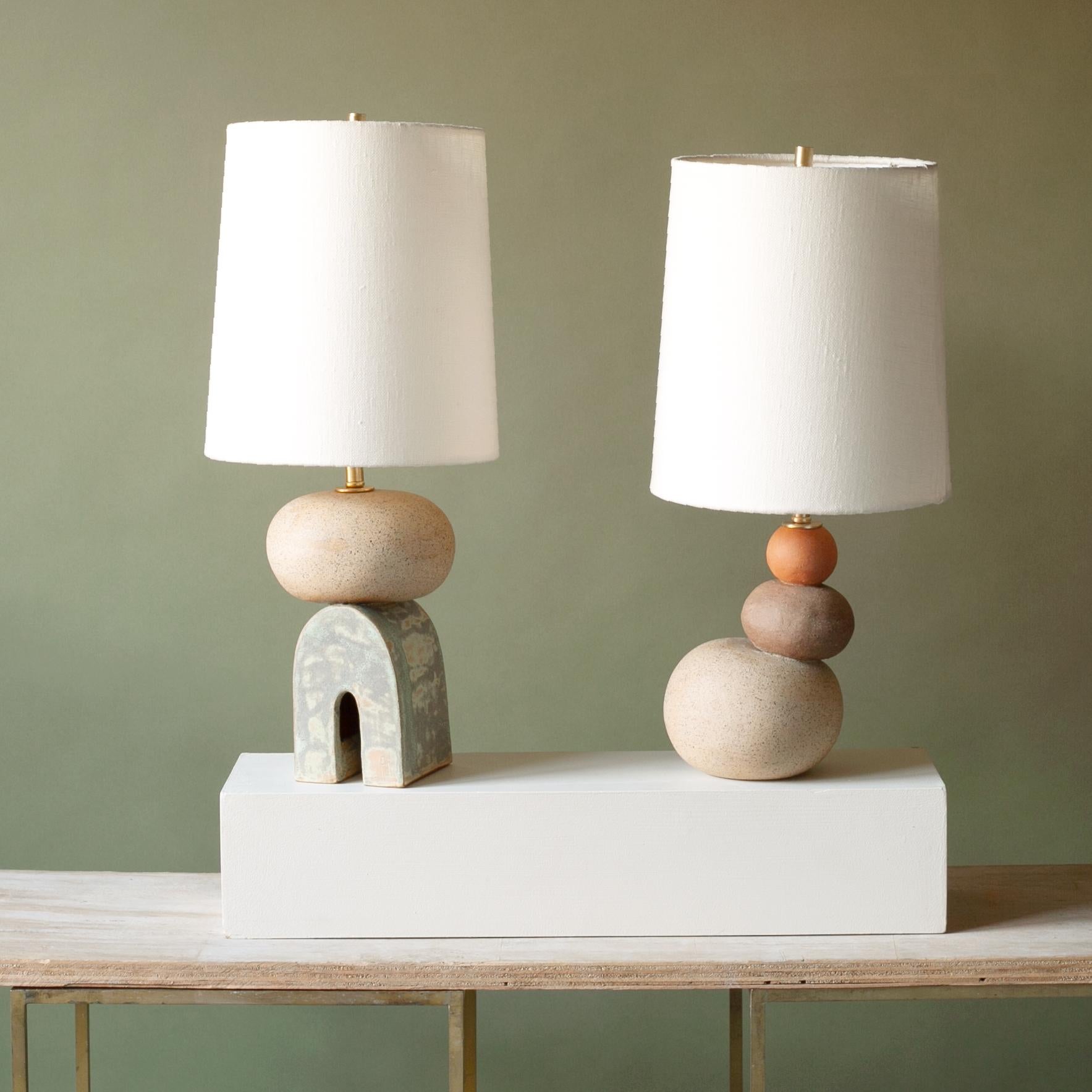 One of a kind set of ceramic lamps, thrown on the potters wheel and assembled by hand. The lamp base is comprised of two different clay bodies, tan speckle top with coppery green glaze. This piece was inspired by seashells and smooth stones
