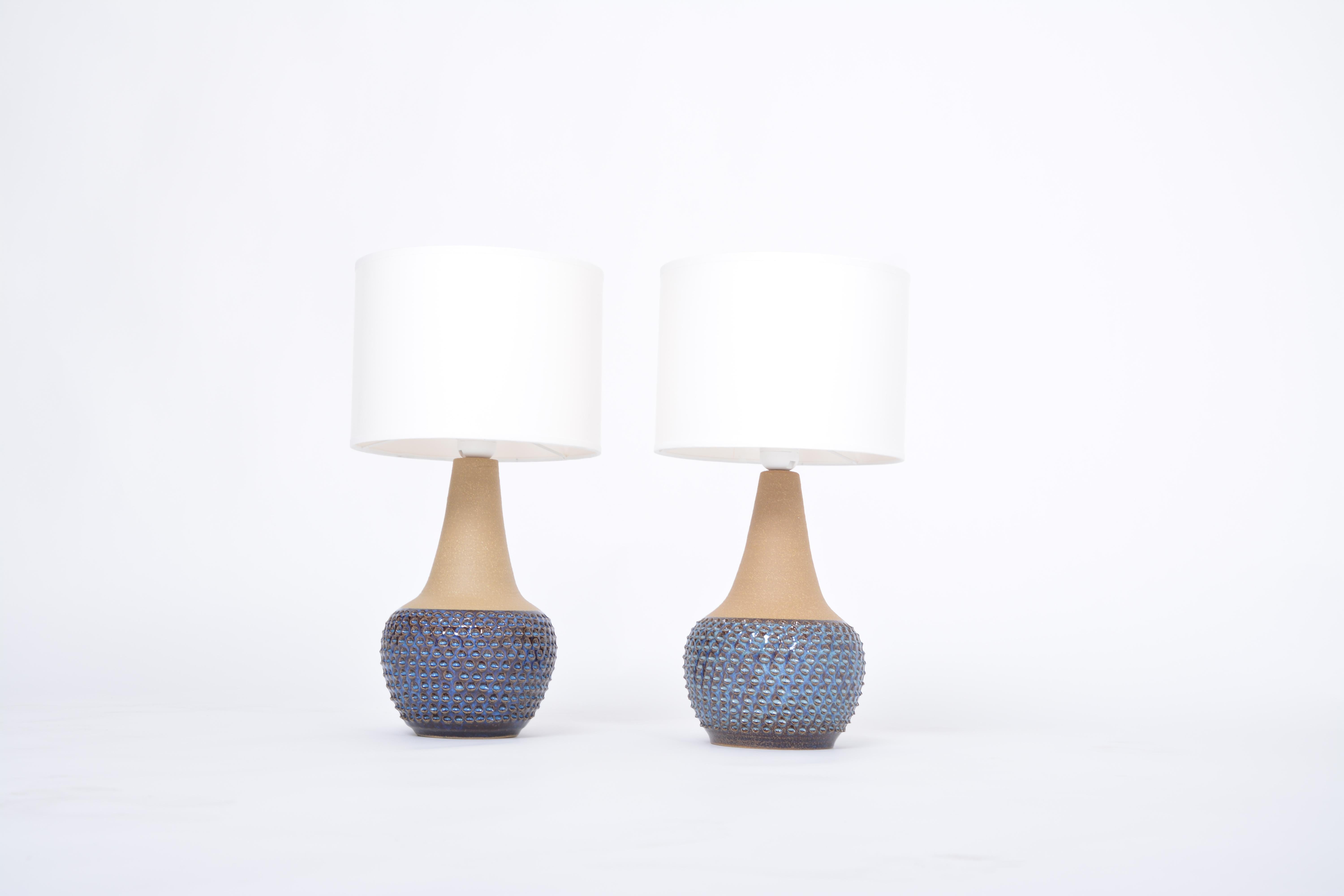 Pair of handmade blue Danish mid-century stoneware lamps by Soholm
Stunning table lamps handmade of stoneware with ceramic glazing in different tones of blue designed by Einar Johansen and produced by Danish company Soholm. The model number is