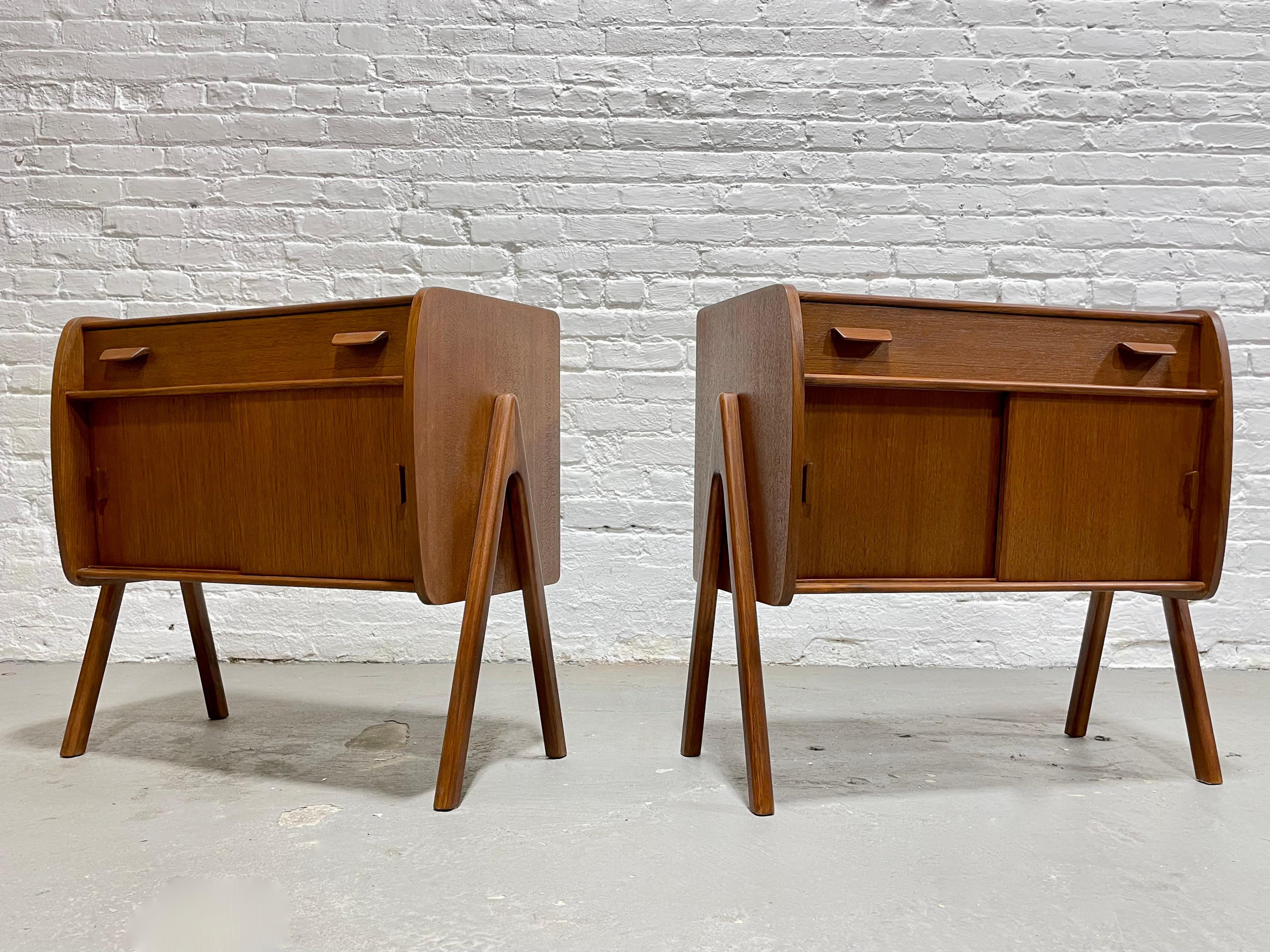 Pair of Handmade Mid-Century Modern styled Teak Cabinets / Entryway Cabinets. Perfect bedside cabinets or storage cabinets anywhere in your home. Fantastic design details such as floating legs, sliding doors and drawer storage and finished back.