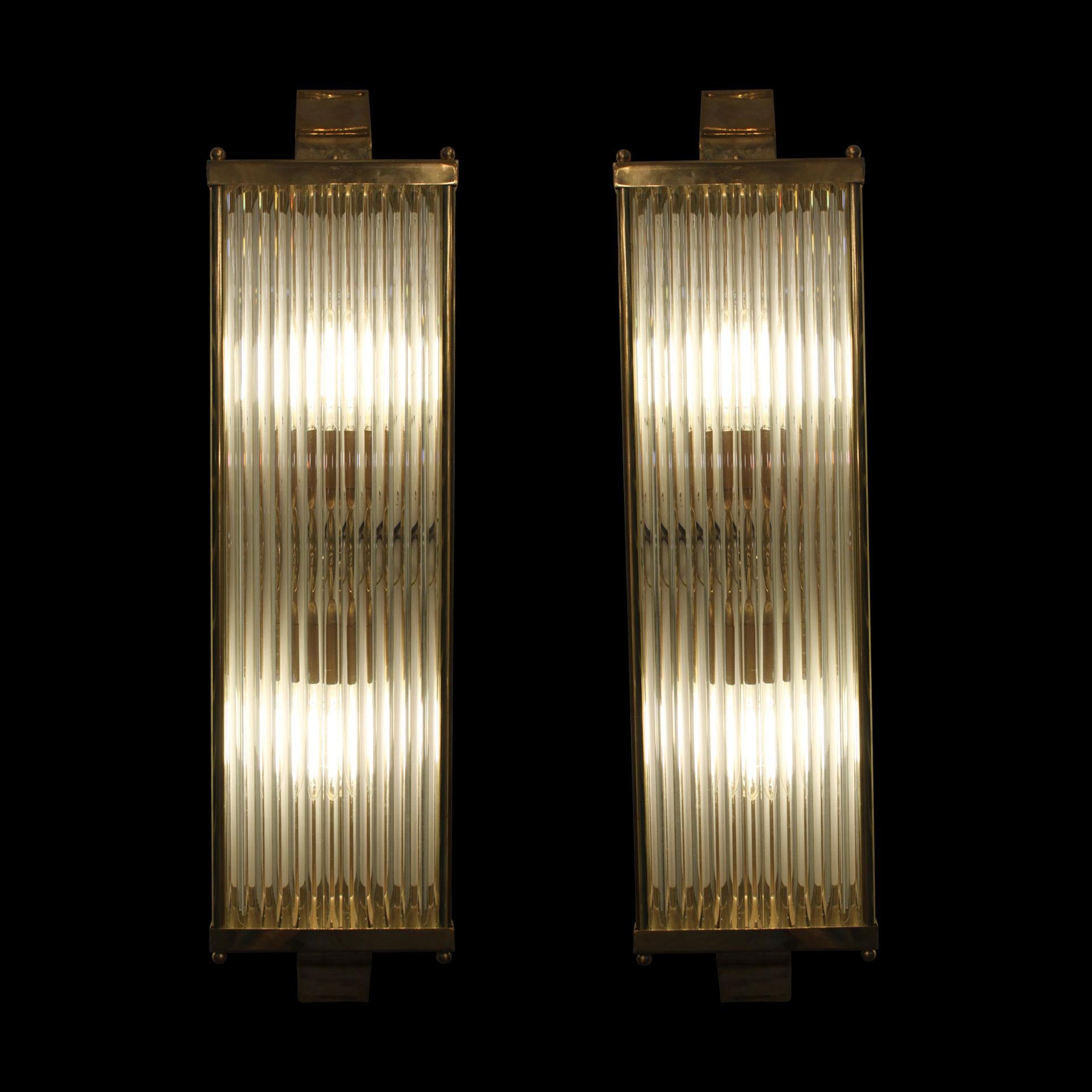 A beautiful pair of handmade Venetian Art Deco style wall lights in polished brass and tubular glass rods on 3 faces with a polished brass rectangular top and base. Featuring 2 bulbs in each lights. A beautiful addition to any entrance hall, room or