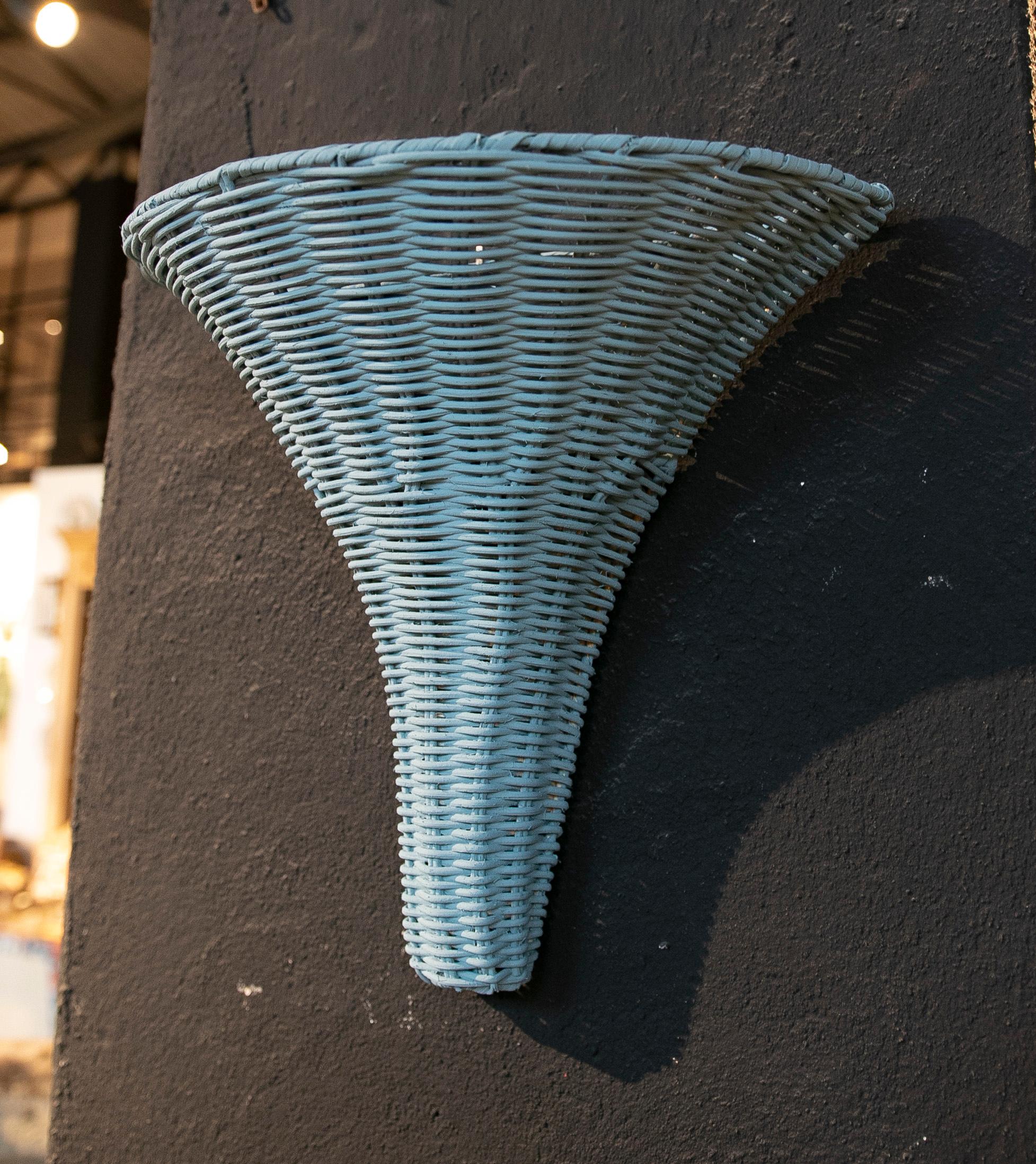 Pair of handmade wicker wall sconces painted in blue.