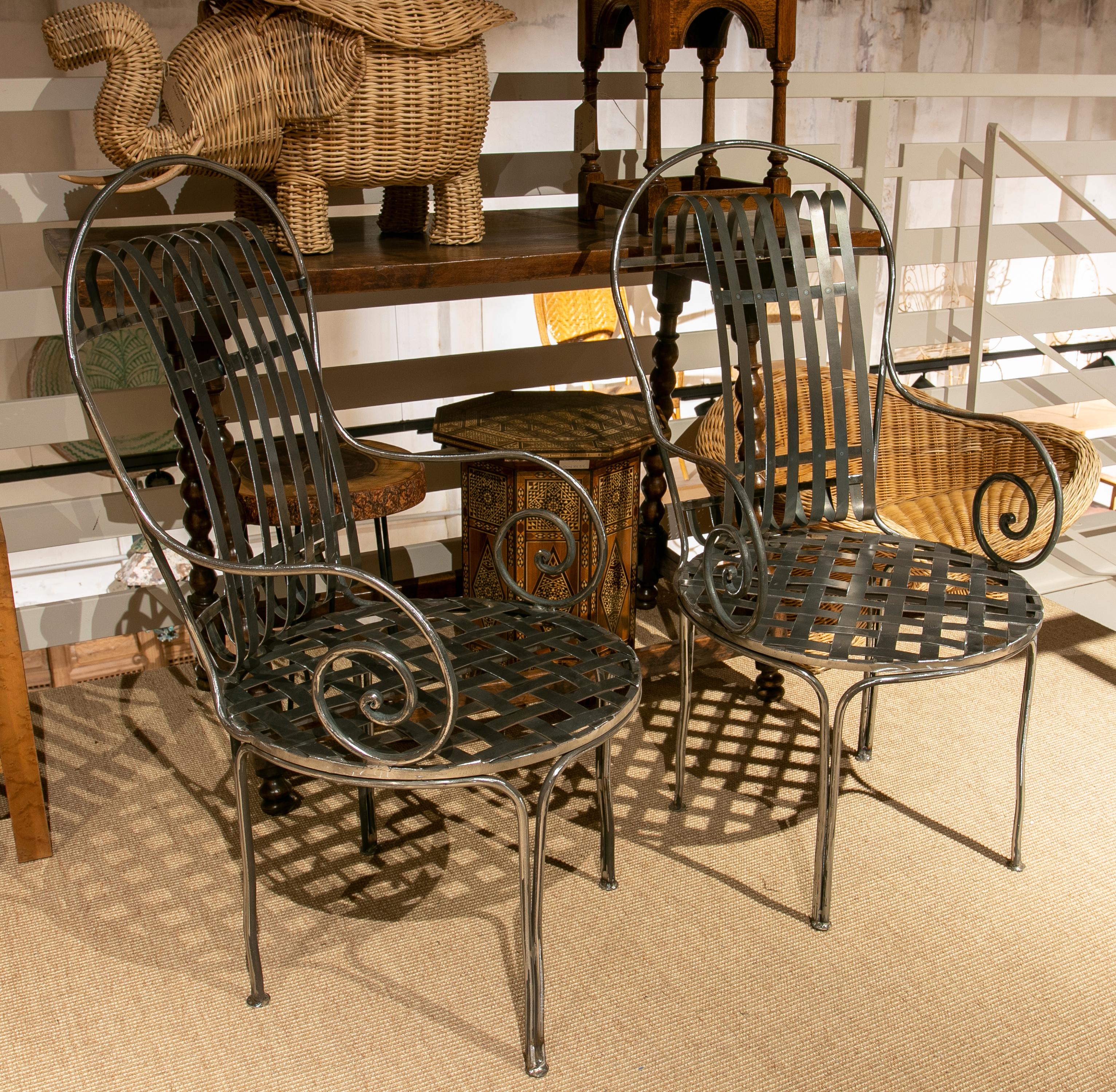 Pair of handmade wrought iron armchairs.