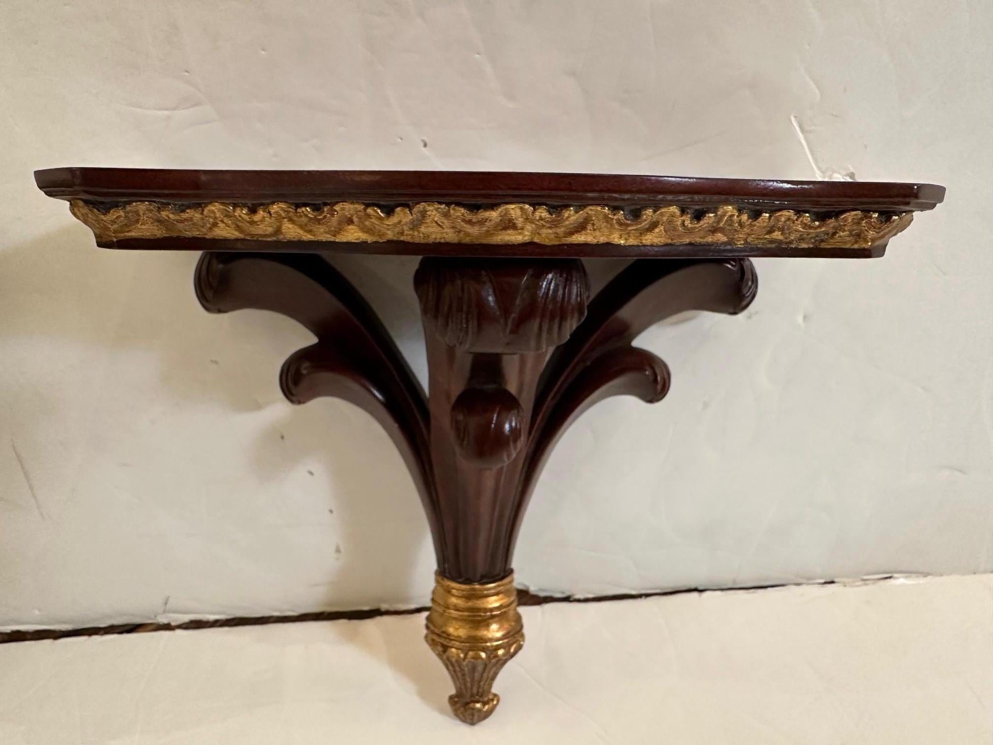 Stunning pair of mahogany and gilt embellished wall brackets with a traditional timeless design.