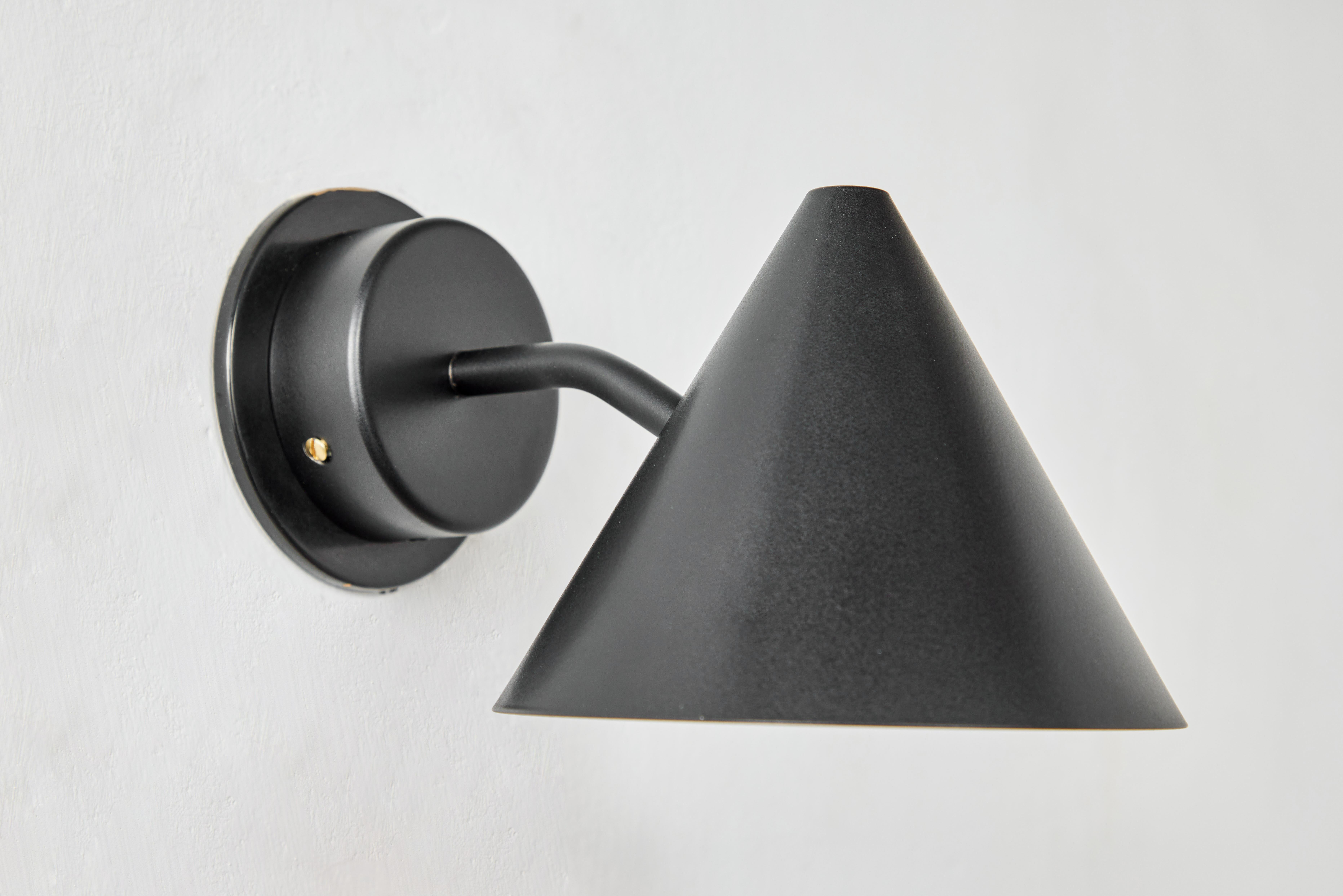 Pair of Hans-Agne Jakobsson 'Mini-Tratten' outdoor sconces in black. An exclusive made for U.S. and UL listed authorized re-edition of the classic Swedish design executed in black painted metal shade with black painted interior and brass hardware.