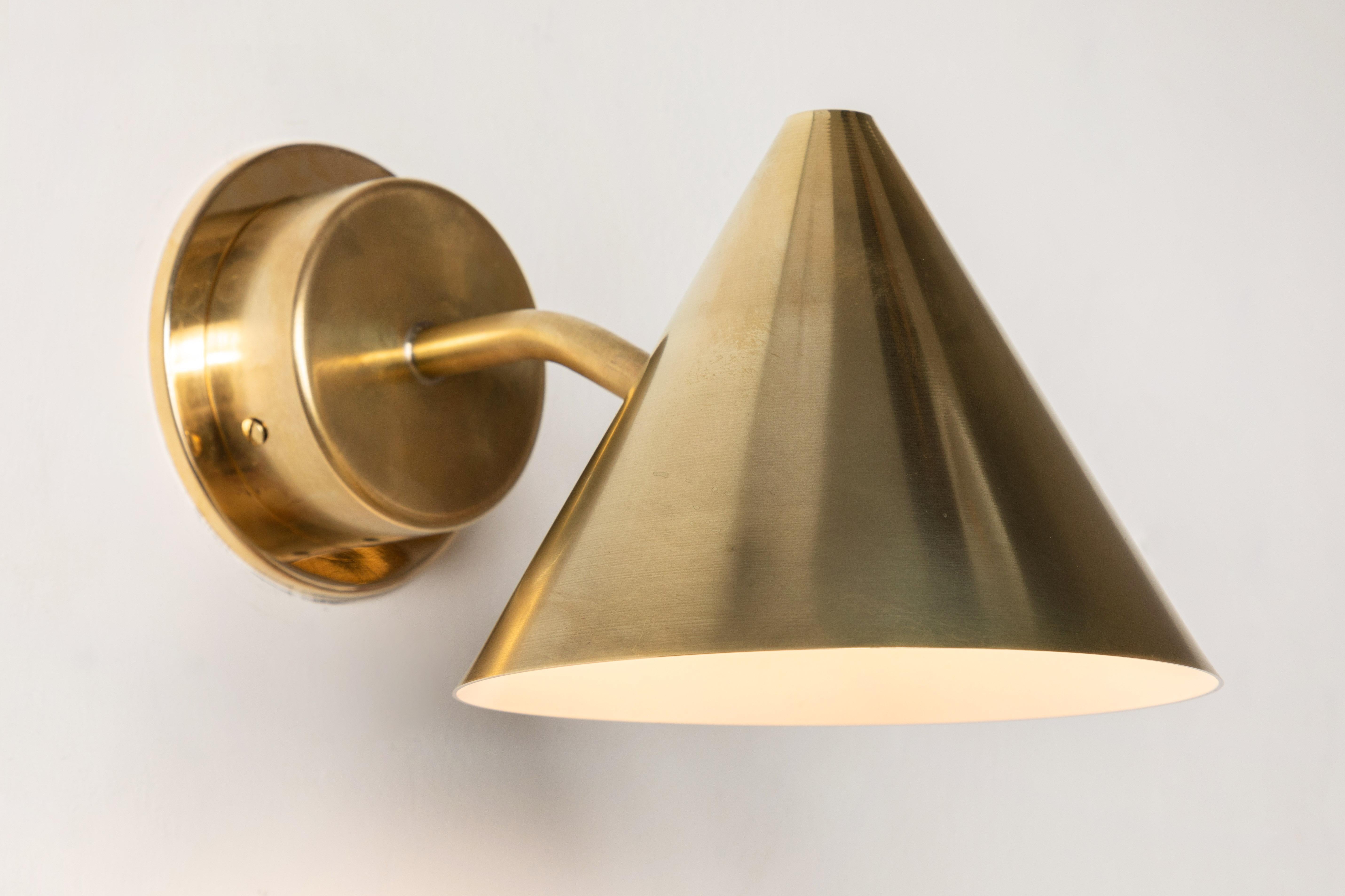 Pair of Hans-Agne Jakobsson 'Mini-Tratten' Raw Brass outdoor sconces. 

An exclusive made for U.S. and UL listed authorized re-edition of the classic Swedish design executed in raw brass with white painted interior. An incredibly refined design that