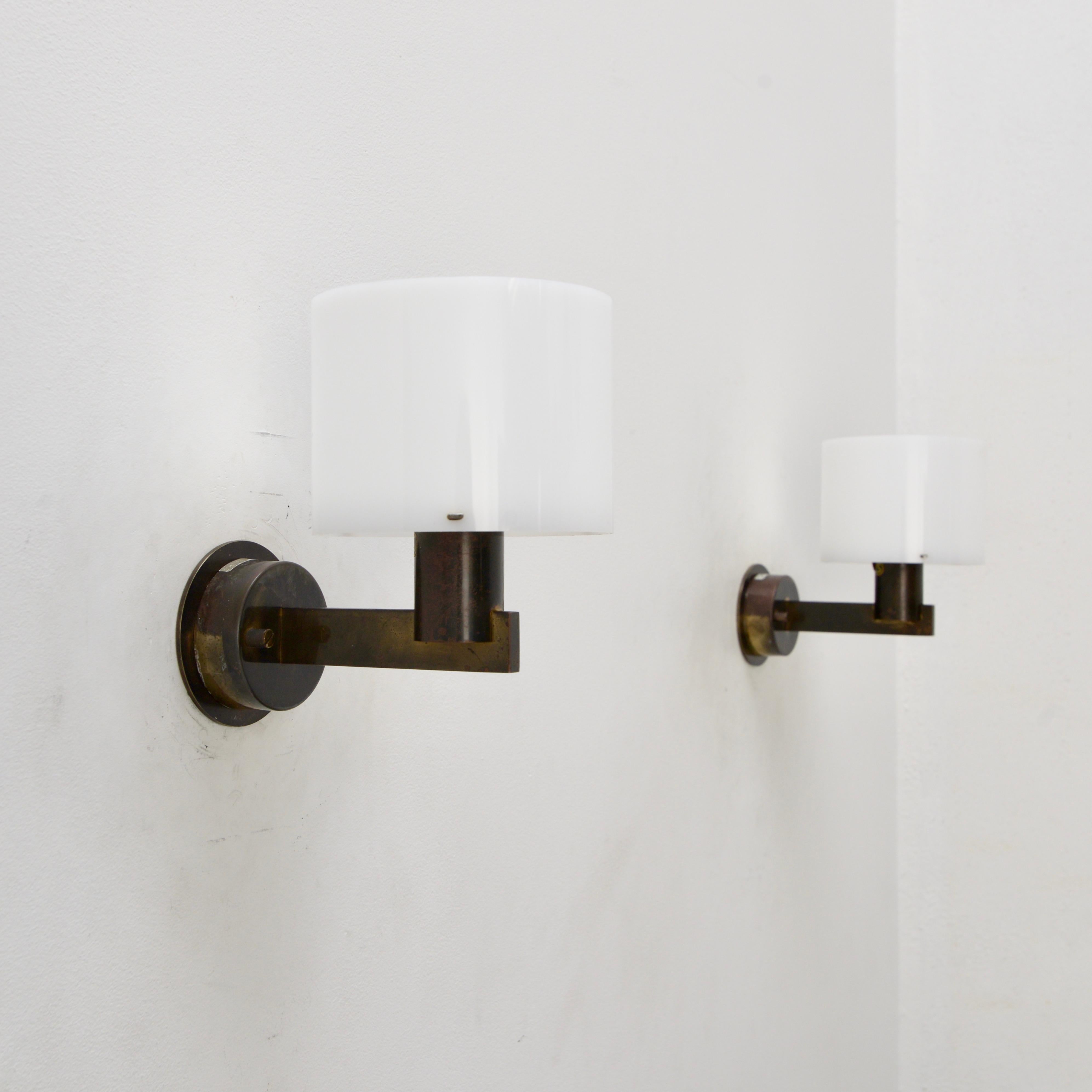Pair of vintage Hans-Agne Jakobsson sconces in steel, brass and acrylic. They are wired with a single E26 socket in each sconce and are for use in the US. But can be wired for use anywhere in the world. Lightbulb included with