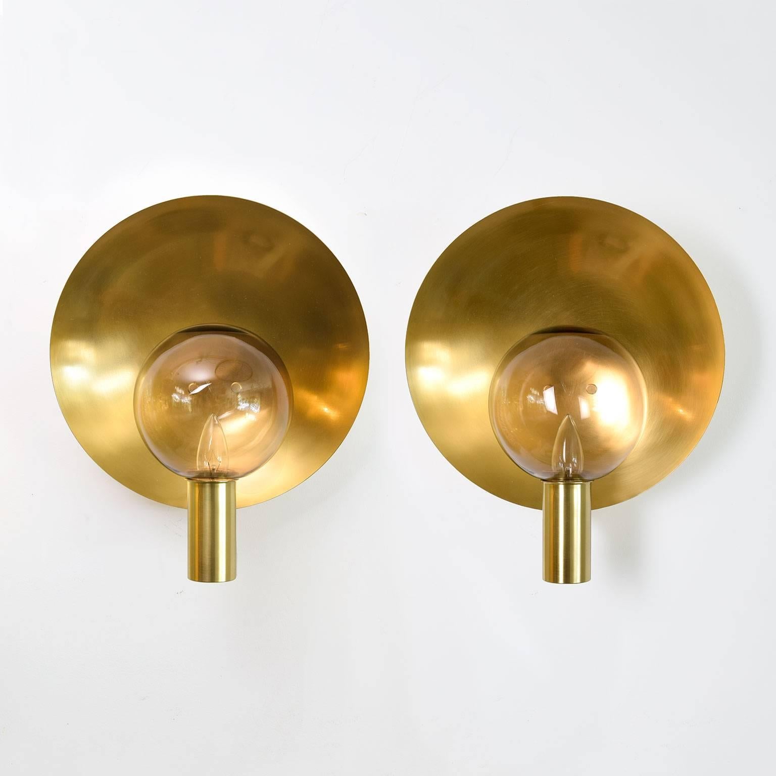 Large pair of Scandinavian Modern polished brass sconces with glass sphere shades. Designed by Hans-Agne Jakobsson for Markaryd, Sweden, circa 1960s. Newly polished and lacquered, newly rewired for use in the USA, each sconces has a single