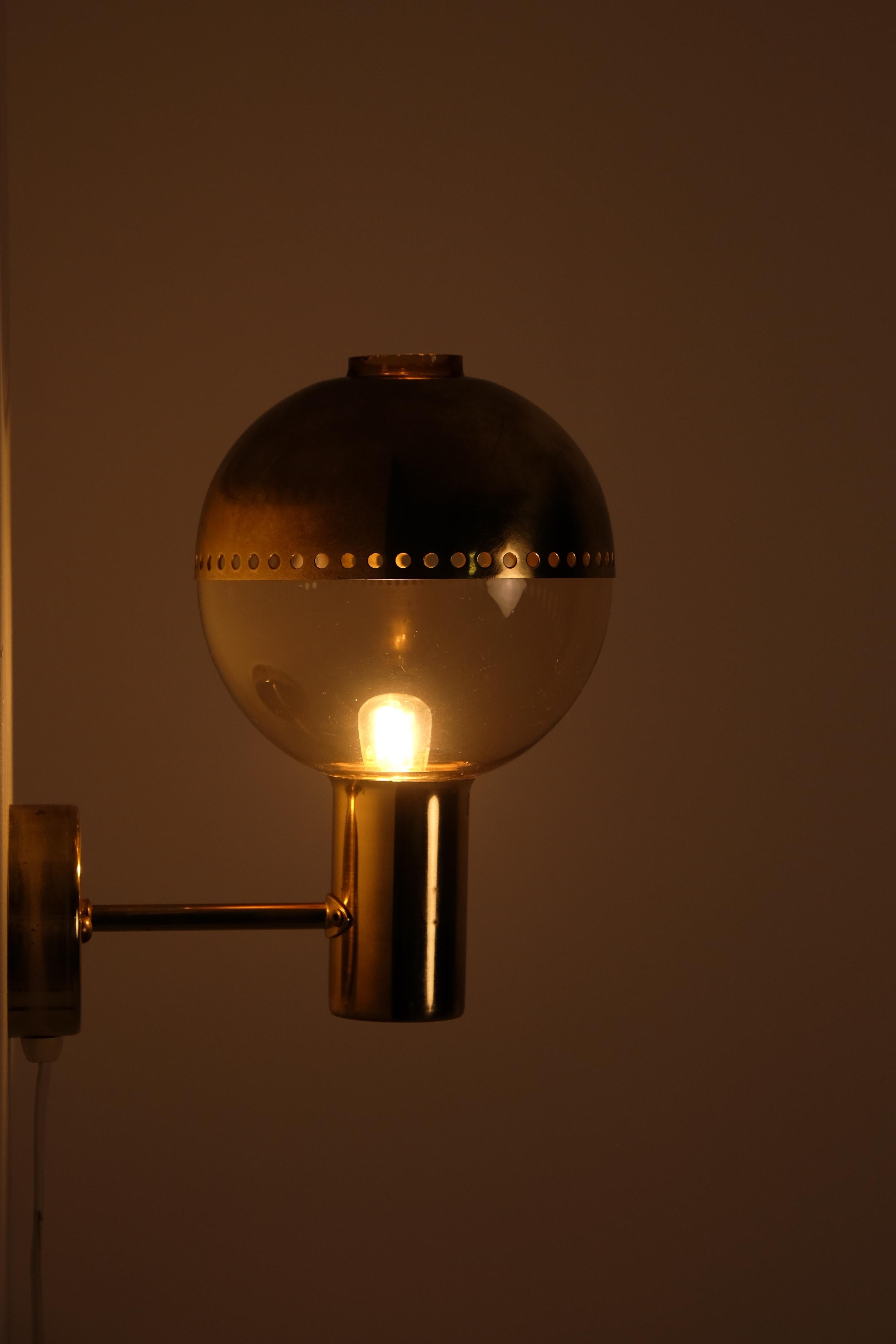 Pair of brass wall lights 'Patricia' with smoked glass and brass top, designed and produced by Hans-Agne Jakobsson, Markaryd, Sweden, 1960s.