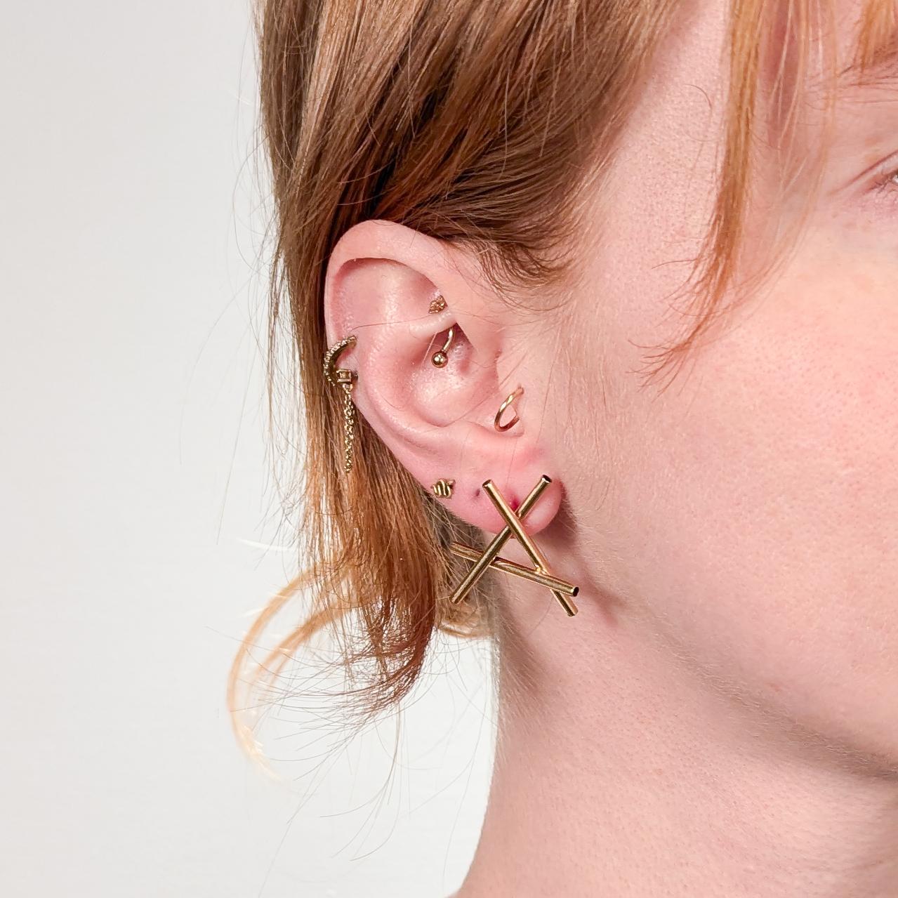 A fine pair of Modernist studio earrings.

In 14k gold.

By Hans Appenzeller, the prominent Dutch Mid-Century jeweler.

With an etched mark to the reverse of each: copyright Appenzeller / 14K

These earrings were likely purchased in Appenzeller's