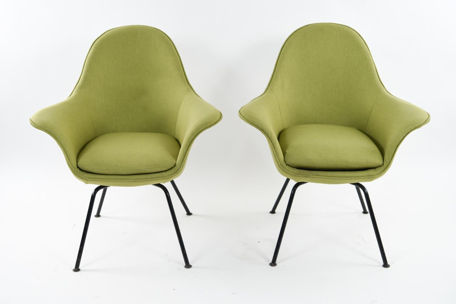 Pair of lounge chairs designed by Hans Bellman for Strässle, Switzerland in 1954. Chairs feature period green gabardine upholstery and black painted metal legs. The fabulous midcentury design of these chairs is matched only by their comfort! Labeled