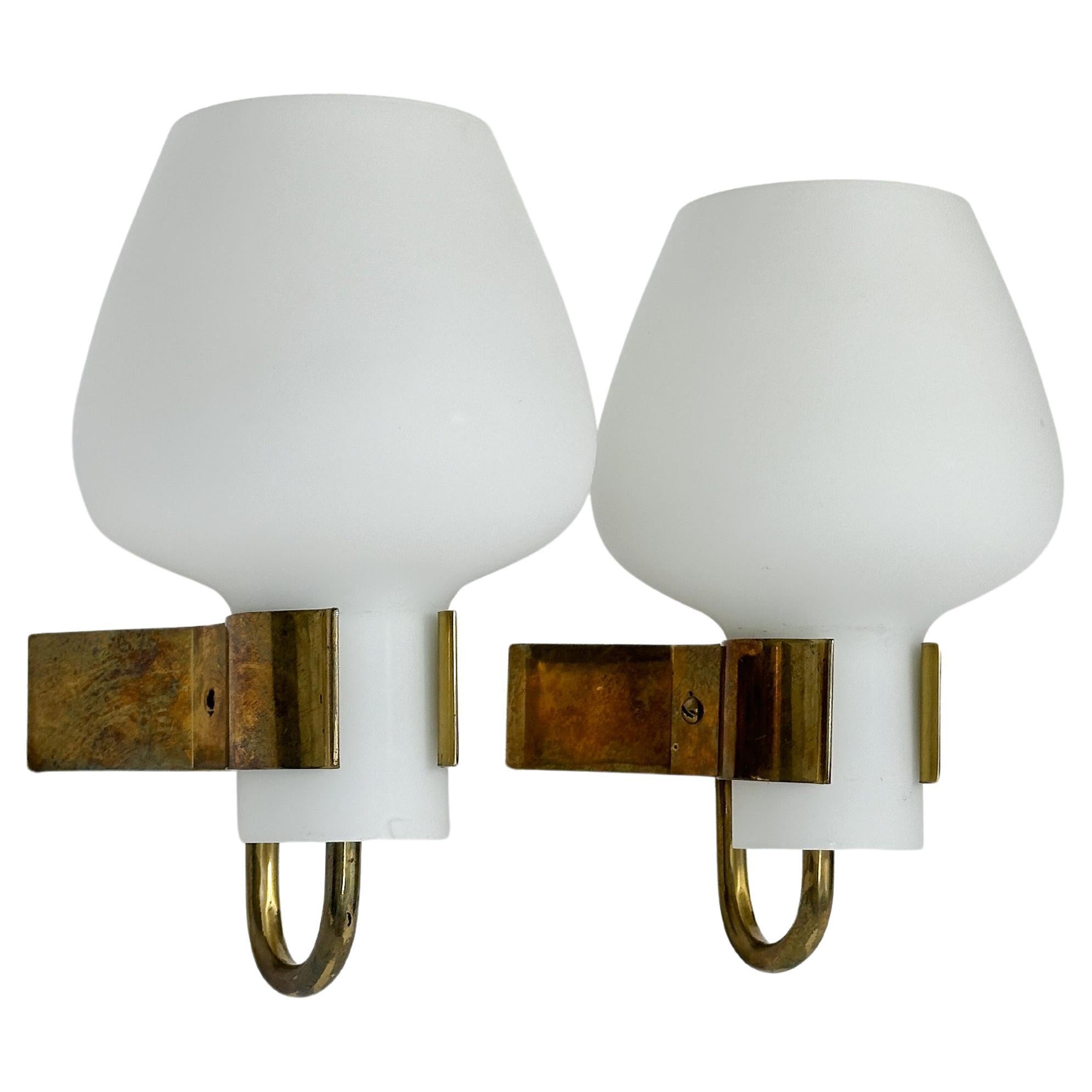 Rare pair of Hans Bergström wall lamps / sconces, model No. 397 for Ateljé Lyktan, made in Sweden in the early 1950s. 

Solid brass construction with hand-crafted opaline glass shades. 
Marked with the manufacturers mark and model number on the