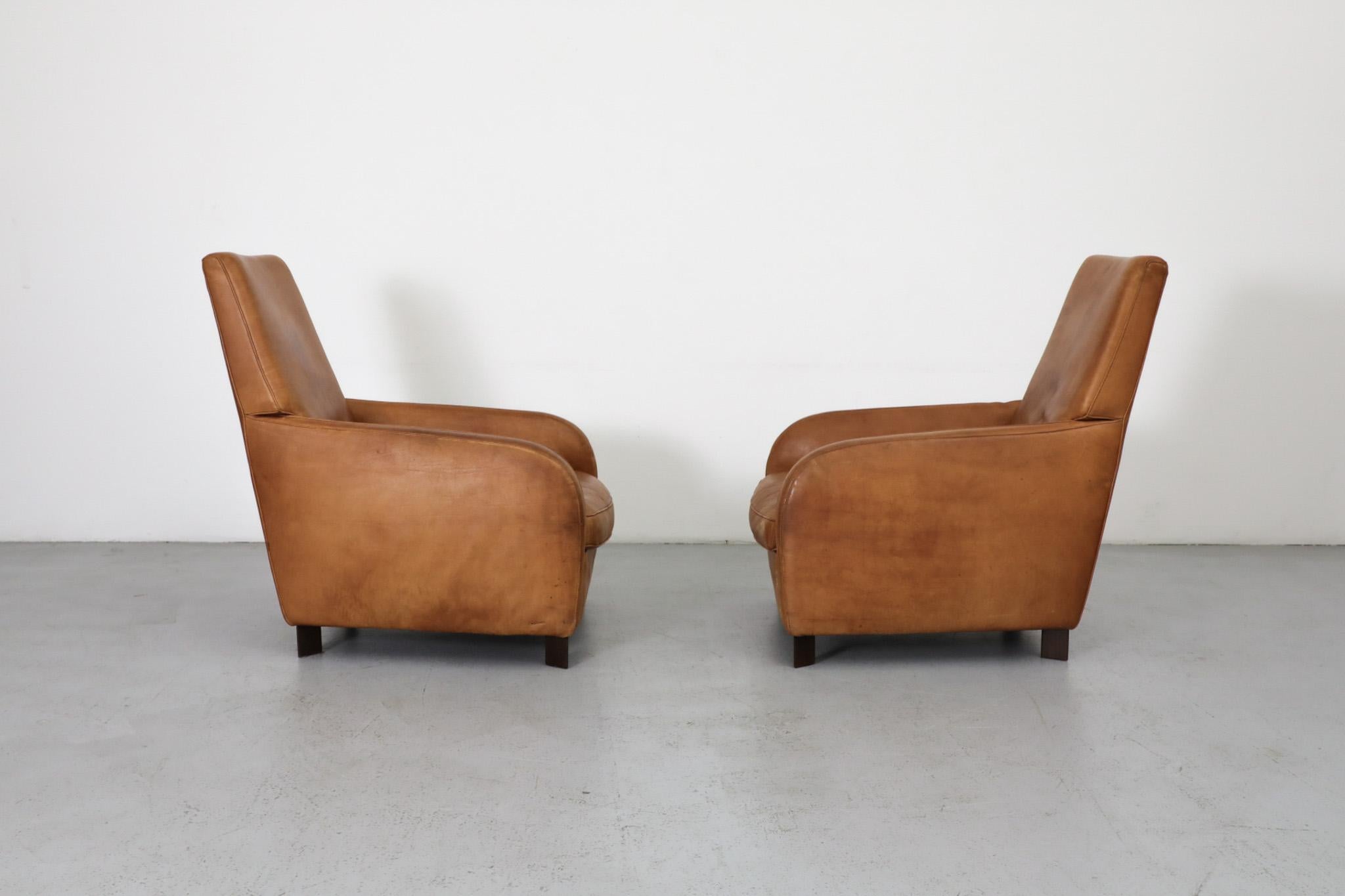 Pair of cognac leather lounge chairs for Molinari from acclaimed German designer Hans Hopfer. Hopfer also designed the celebrated 'Mah Jong' Sofa System for Roche Bobois - the companies most recognized and iconic design. Extremely comfortable and