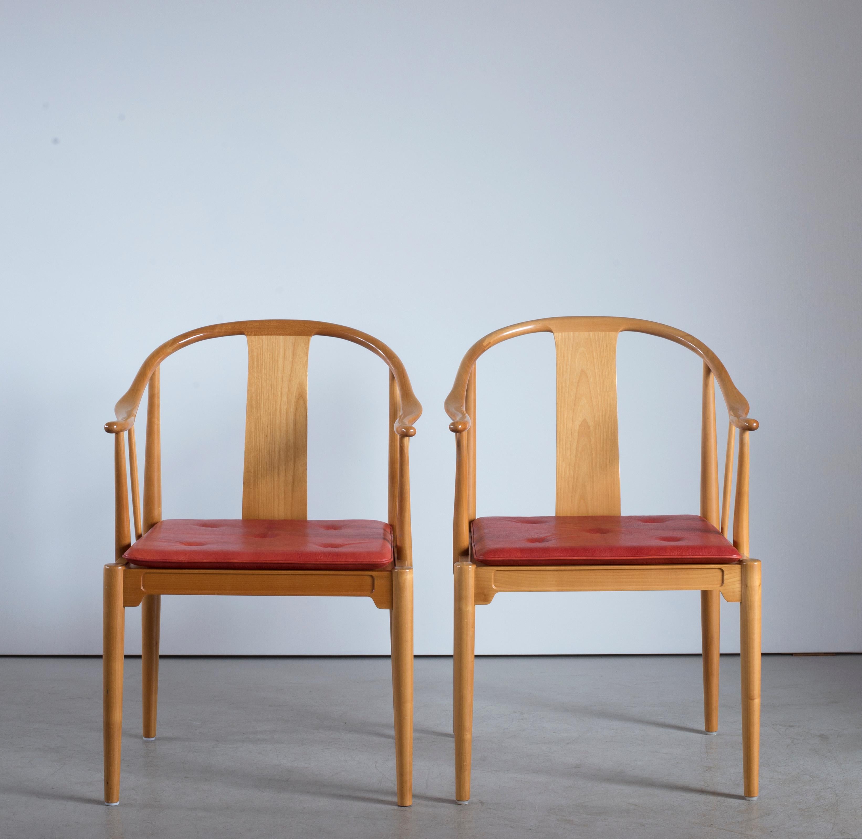 Hans J. Wegner Chinese chairs of cherrywood. Loose seat cushion upholstered with red leather, fitted with buttons. Executed by Fritz Hansen, 1976.

Reverse with paper label FRITZ HANSEN, DENMARK.

  