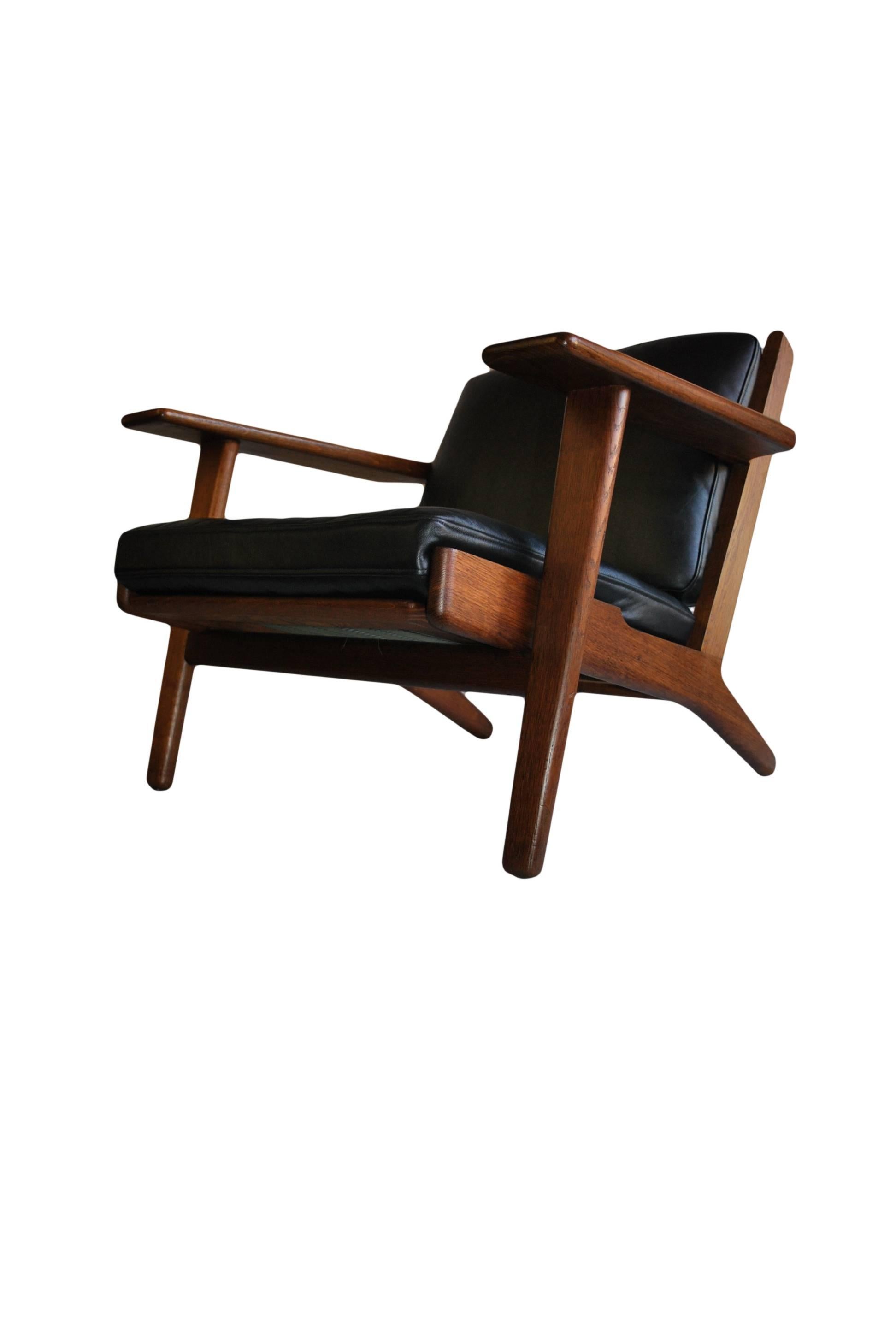 Very unusual fumed oak version of the classic Hans J Wegner GE290 lounge chair. Produced by GETAMA, Denmark, 1950s. Makers and designers marks still intact to underside. Completely refurbished frame with new feather down cushions (or metal sprung if