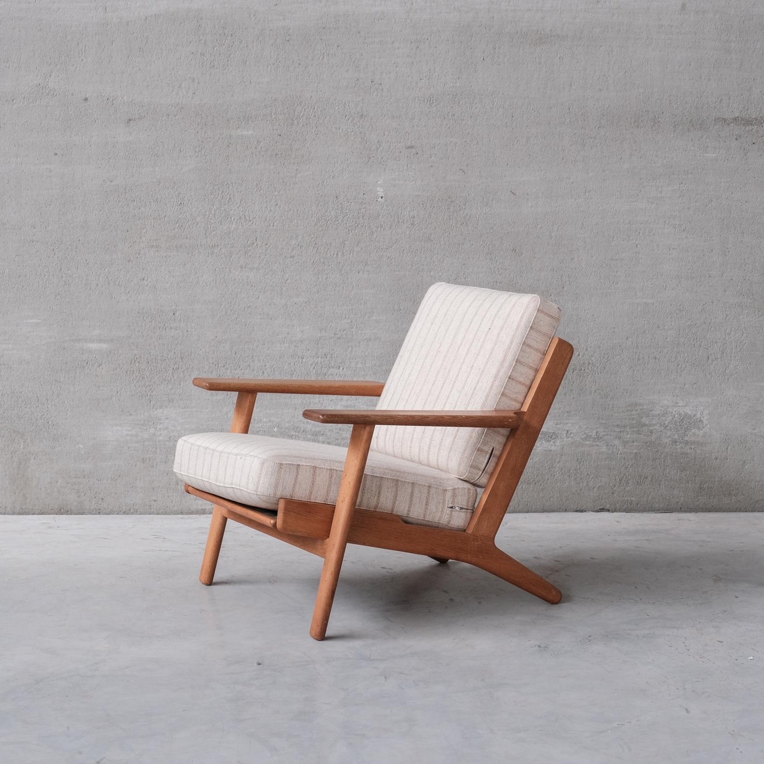 An increasingly hard to find lounge chair by legendary designer Hans J Wegner. 

Denmark, circa 1960s. 

Solid oak. GE-290 Model. 

Stamped to underside. 

Price for the pair. 

Original upholstery retained, in relatively good condition.