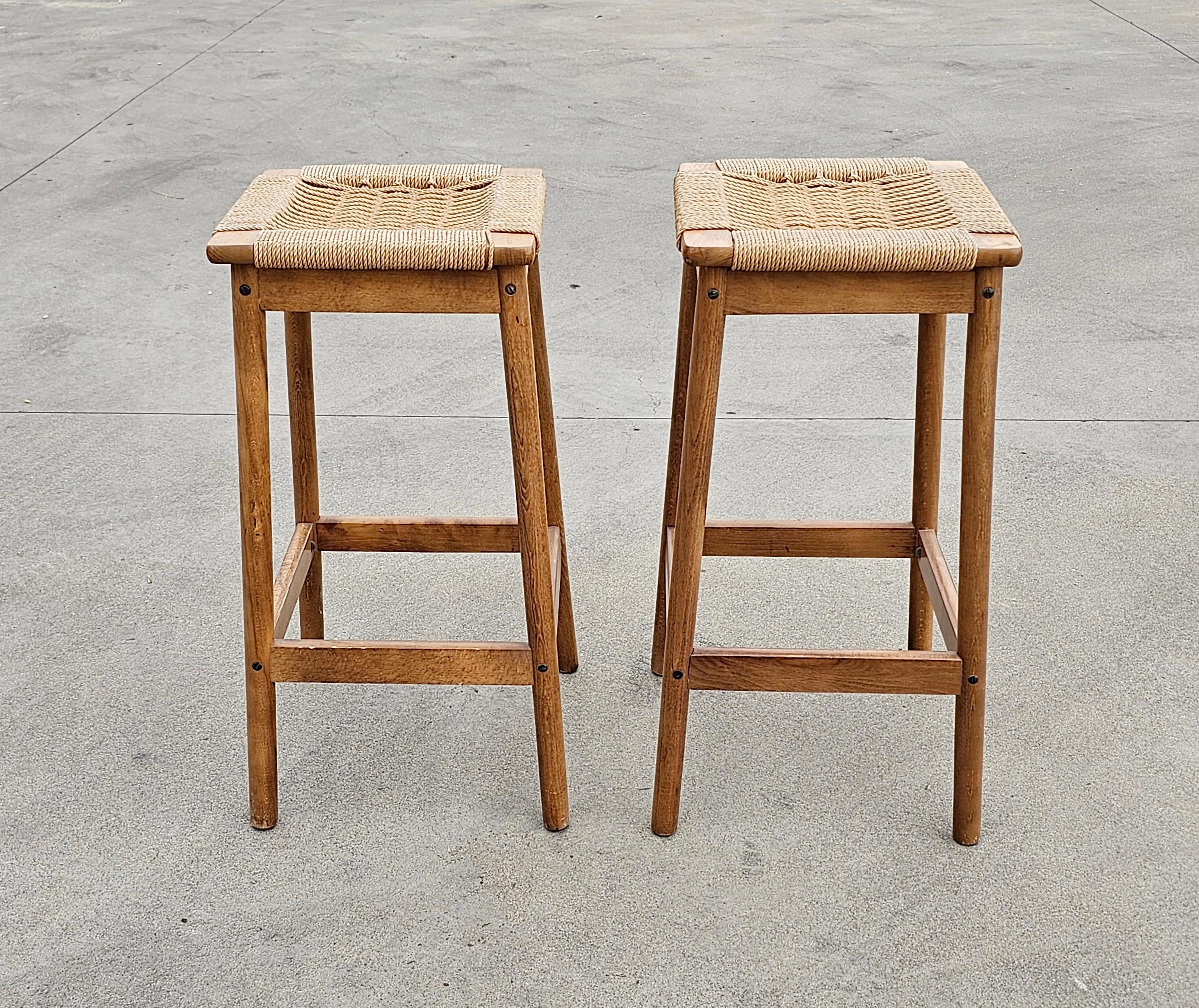 In this listing you will find a pair of very rare and gorgeous Mid Century Modern Bar Stools done in oak, with Danish paper cord seats. The stools are designed in the manner of Hans J. Wegner. Elegant, simple and timeless! Made in Yugoslavia in