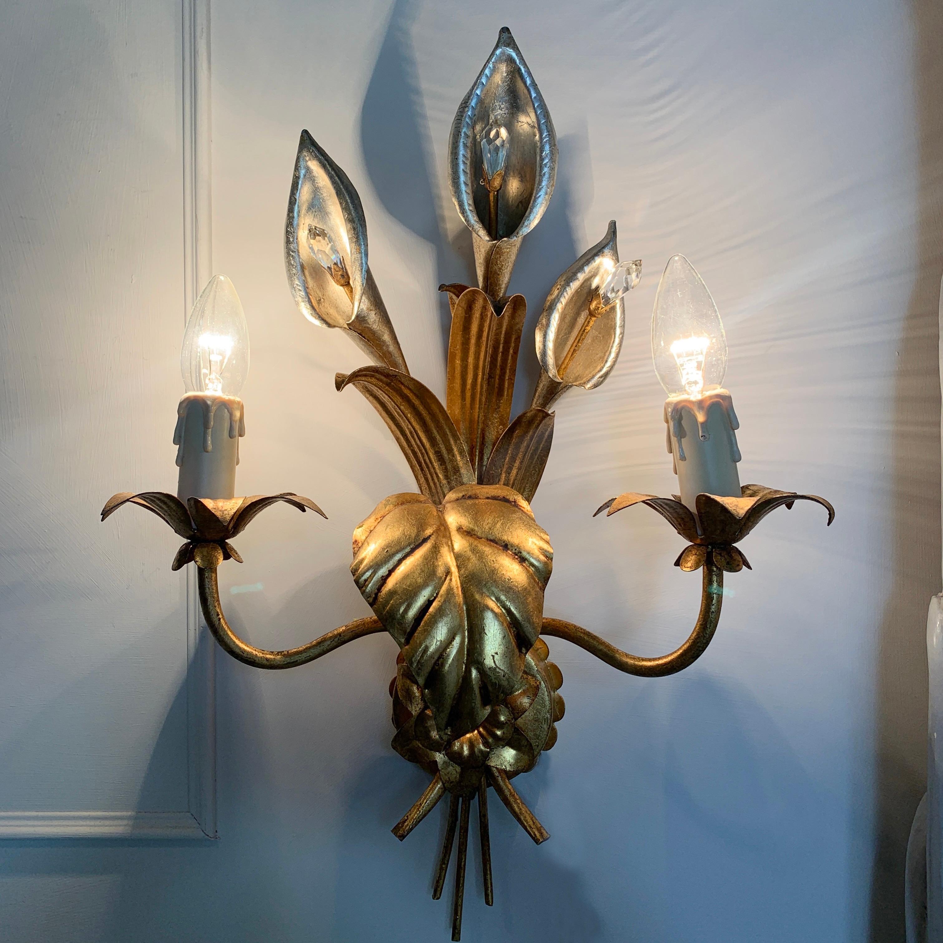 Pair of Hans Kögl calla lily wall sconces, c 1970's
Stunning silver and gilt calla lily flower design

Each silver calla lily has a central faceted Swarovski crystal stamen
There are 2 bulb holders with faux candle covers

Large and slim calla