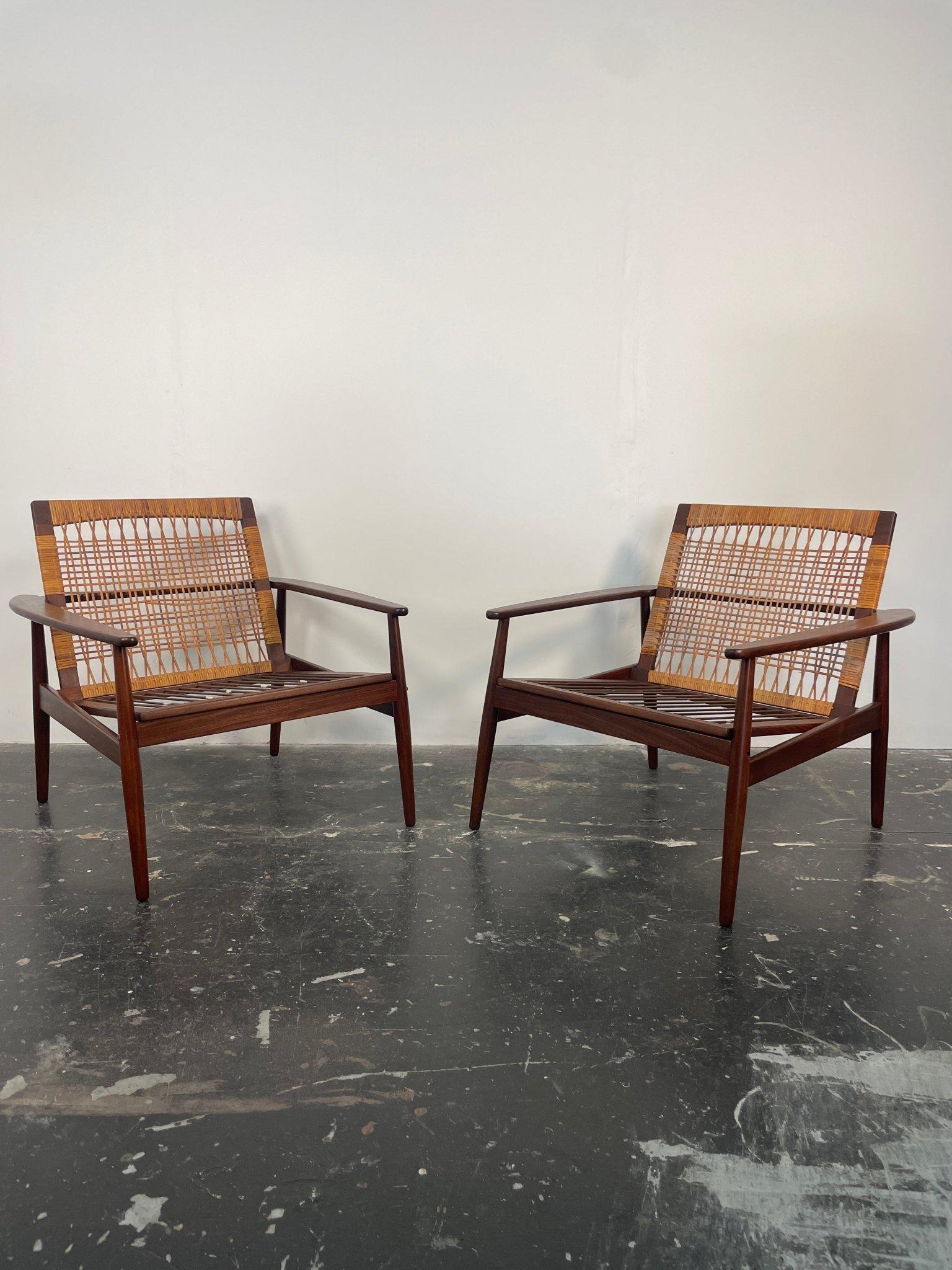 Pair of Danish modern lounge chairs designed by Hans Olsen for Juul Kristensen in Denmark circa 1960s. This iconic chair design by Hans Olsen is constructed from solid Aframosia teak wood that is found only in Africa, its original Danish cane