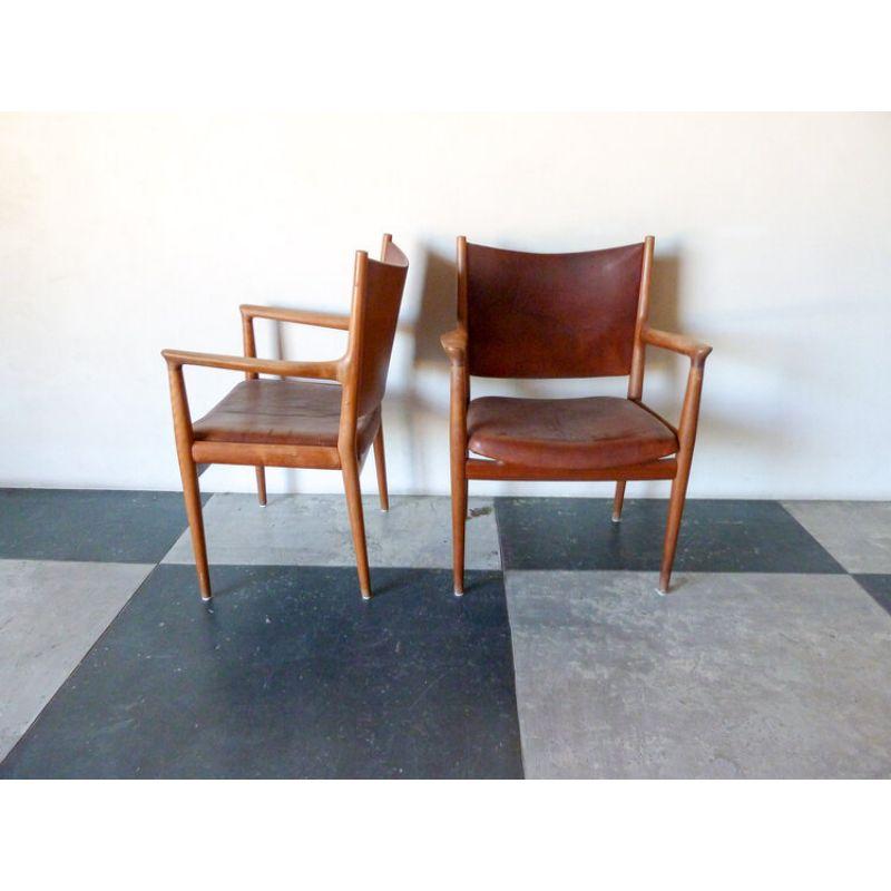 Pair of armchairs by Hans J Wegner, Model JH-713. Two armchairs framed in solid teak and seat original upholstered in cognac-colored leather. Designed in 1960, produced by Johannes Hansen.

Approx dimensions: 33 3/4