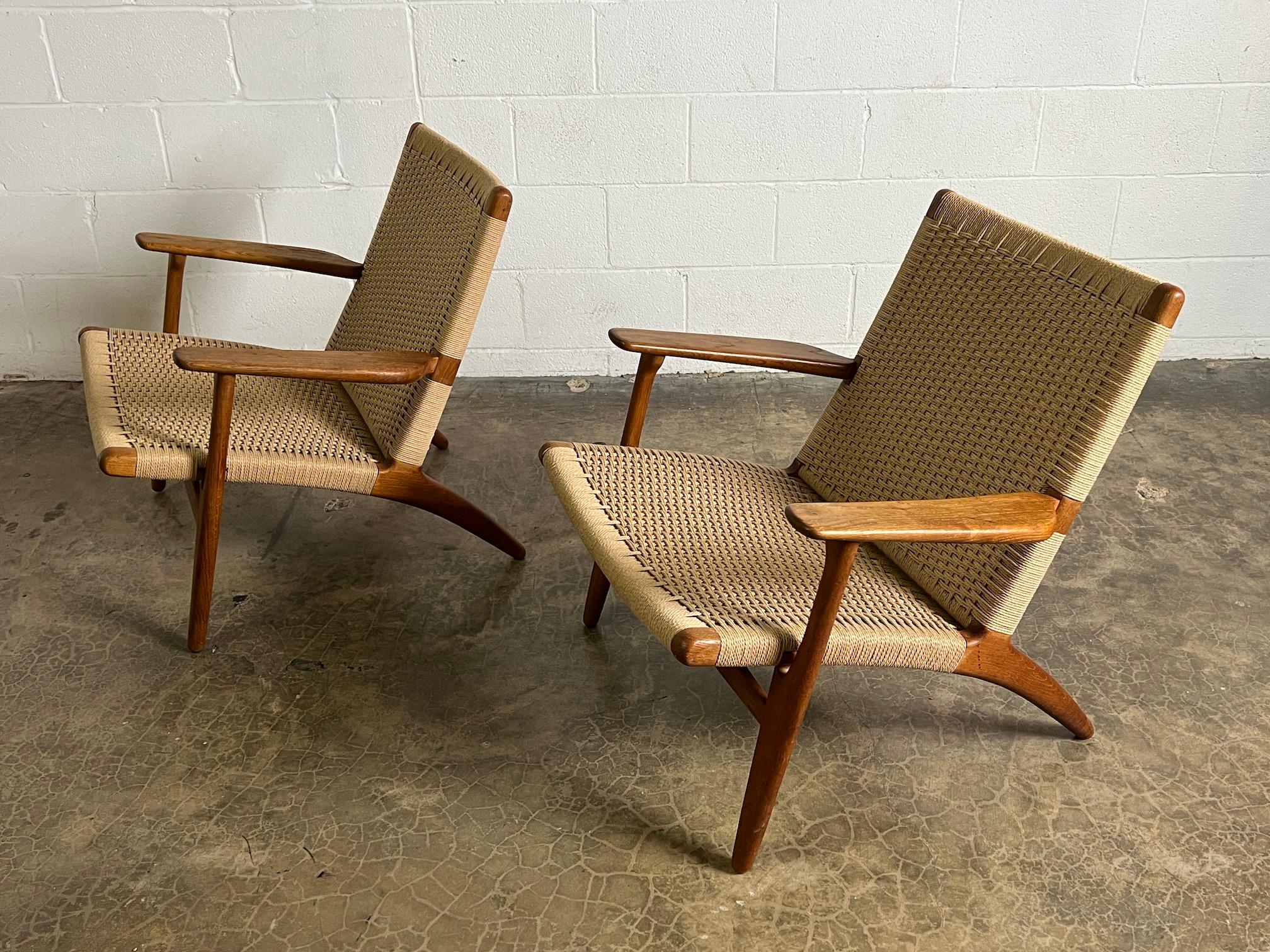 A beautiful pair of Oak and Danish cord CH-25 lounge chairs by Hans Wegner for Carl Hansen & Son.