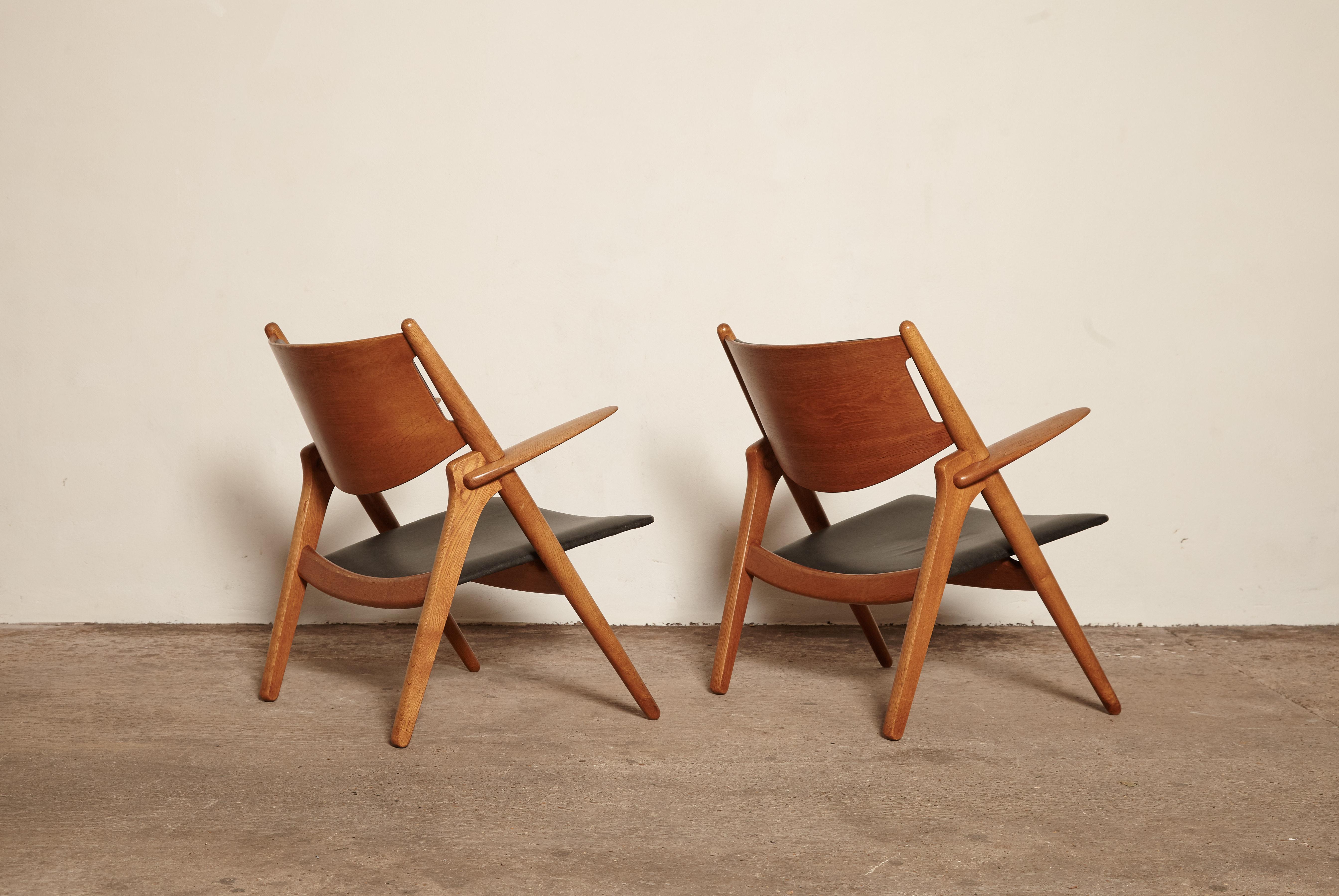 Leather Pair of Hans Wegner CH 28 Sawbuck Armchairs, Denmark