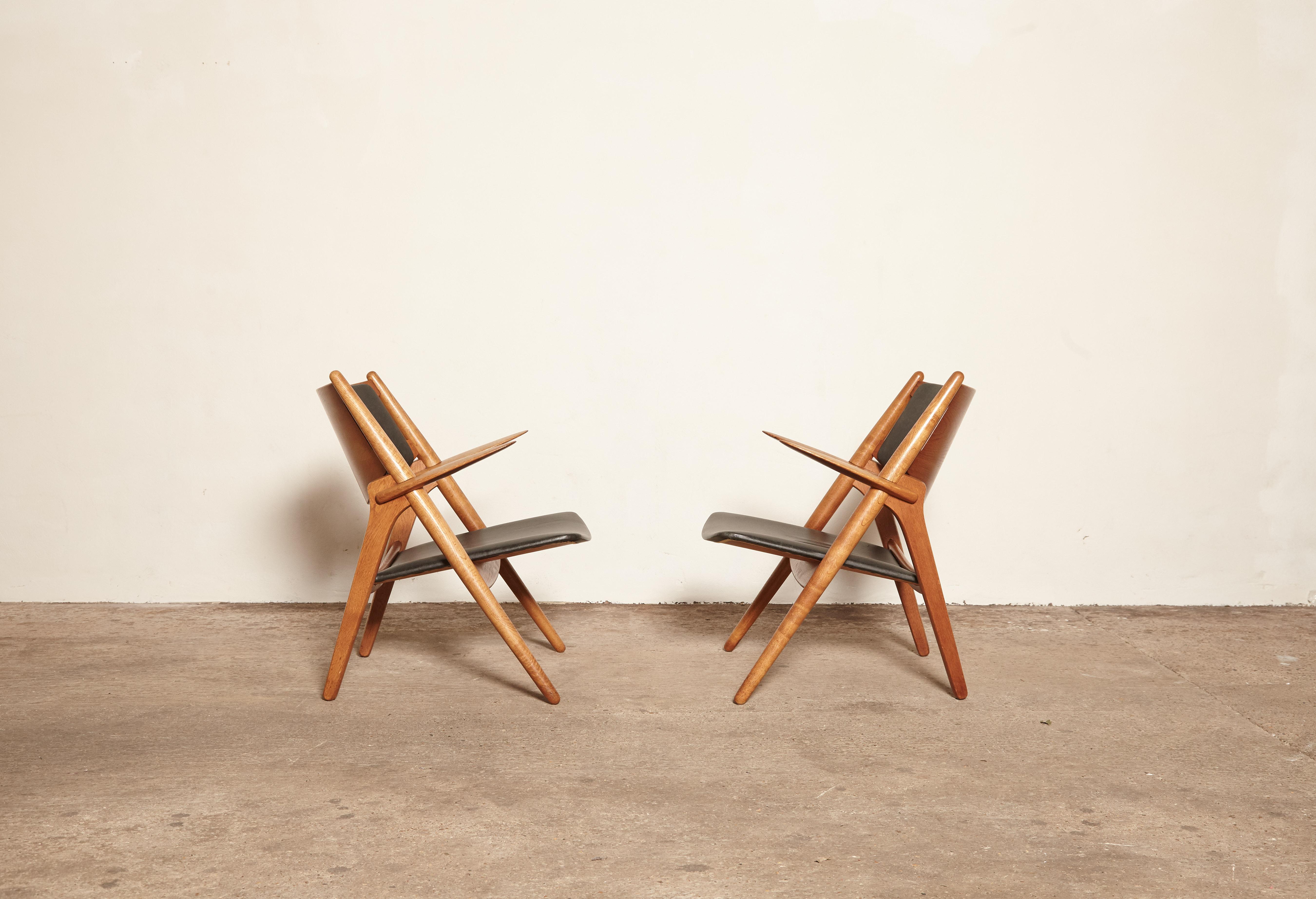 A pair of oak Hans Wegner CH-28 sawbuck armchairs with leather seats. Made by Carl Hansen and Son, Denmark.   With the makers mark of the Carl Hansen craftsman who made the chairs.    Ships worldwide.





UK customers please note:    displayed