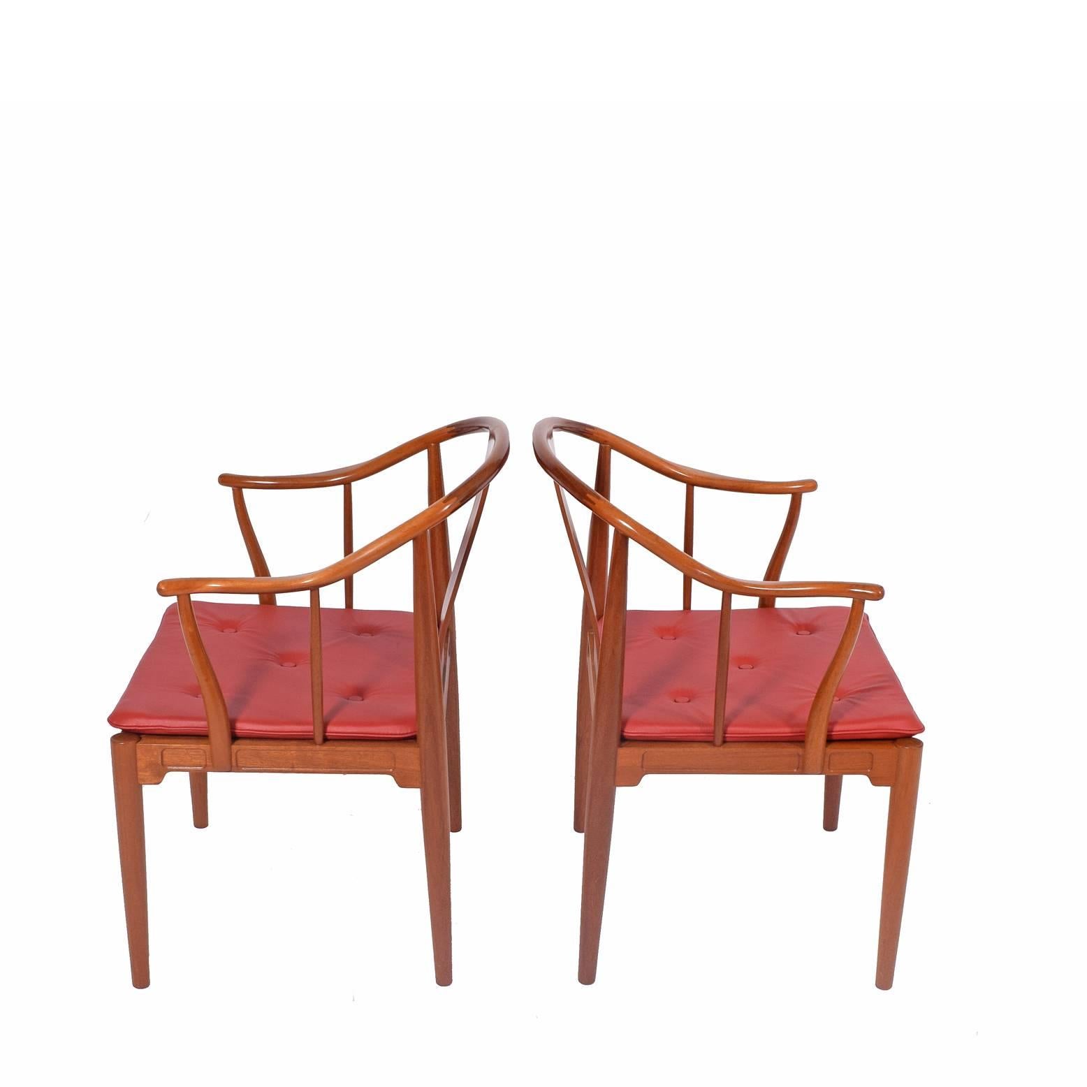 Solid mahogany armchairs with red leather cushions designed by Hans Wegner for Fritz Hansen in 1944. Inspiration came from a 1400 Chinese chair he saw in a museum.
