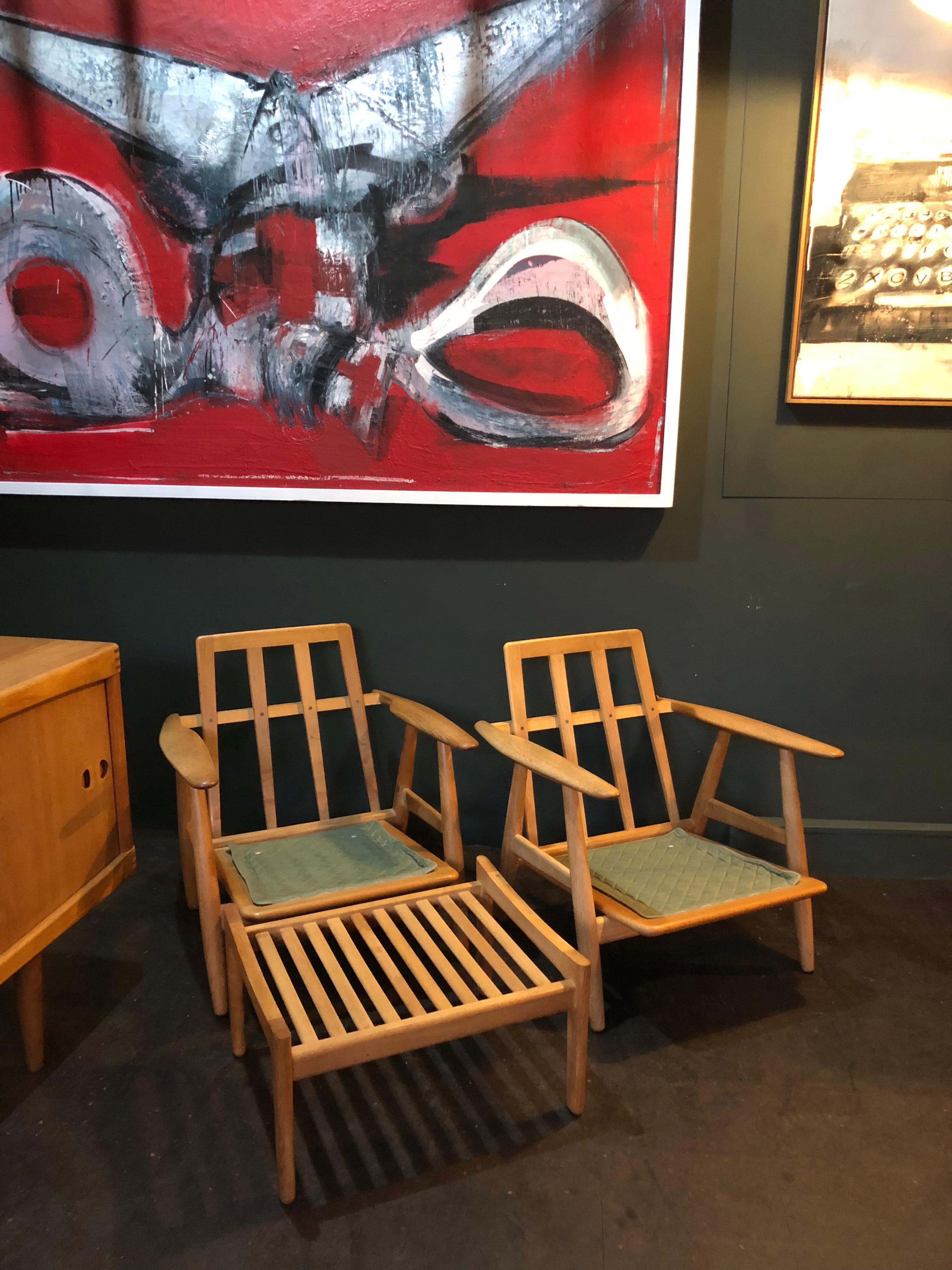 A matching pair of Hans Wegner ge240 cigar chairs with their ottomans. These are original 1950s models from GETAMA with makers and designers marks still intact. Constructed from European white oak. These are in magnificent condition, have been