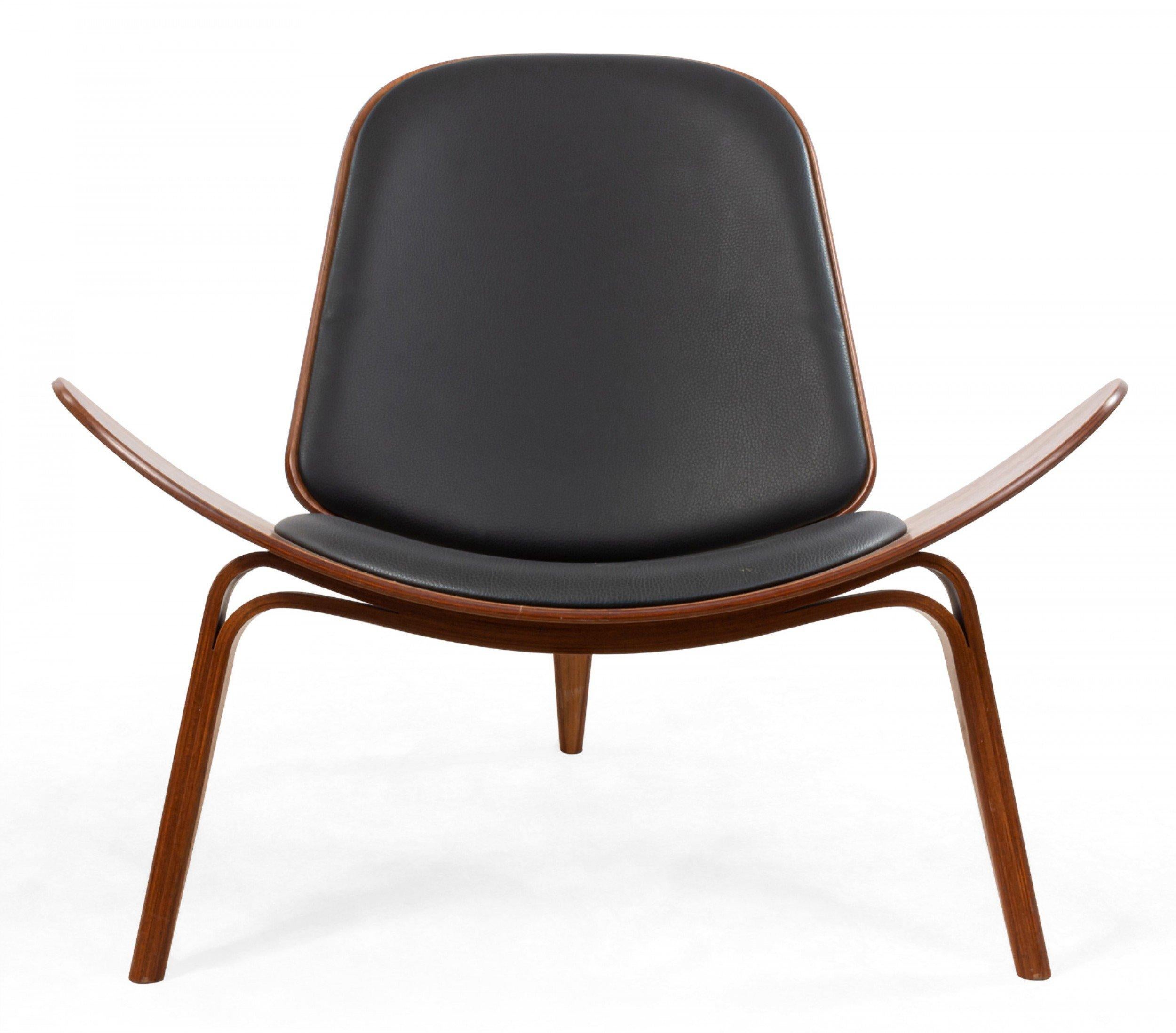 Pair of Hans Wegner for Carl Hansen & Søn CH07 shell chairs with bentwood construction, walnut veneer, lacquered edges, and black leather upholstery, label with serial number attached at base.