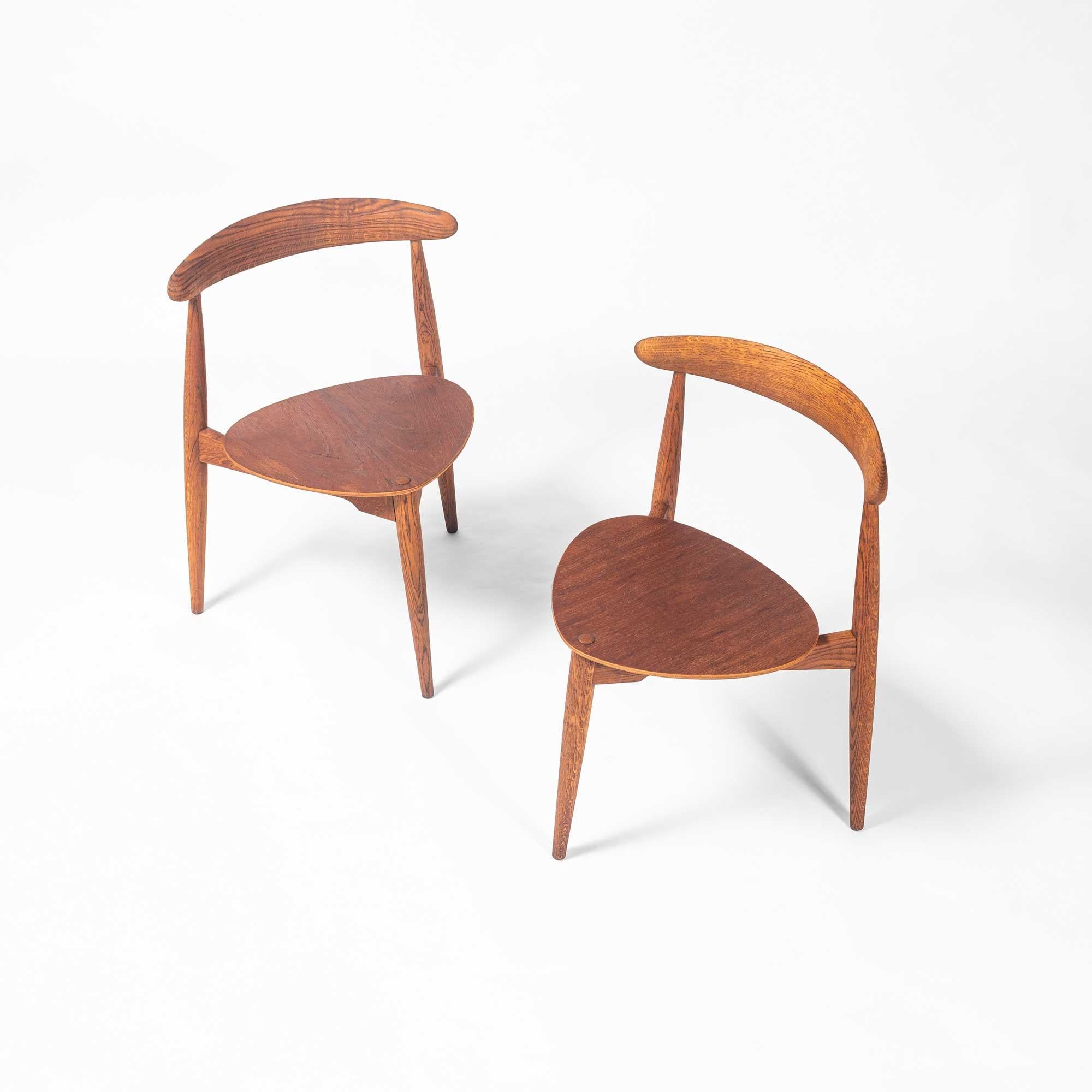Pair of dining chairs model FH4103, is designed by Hans Wegner in 1953. The chairs are designed to take up as little space as possible whilst at the same time having a simplistic, natural and timeless aesthetics. The chairs have only three legs, so