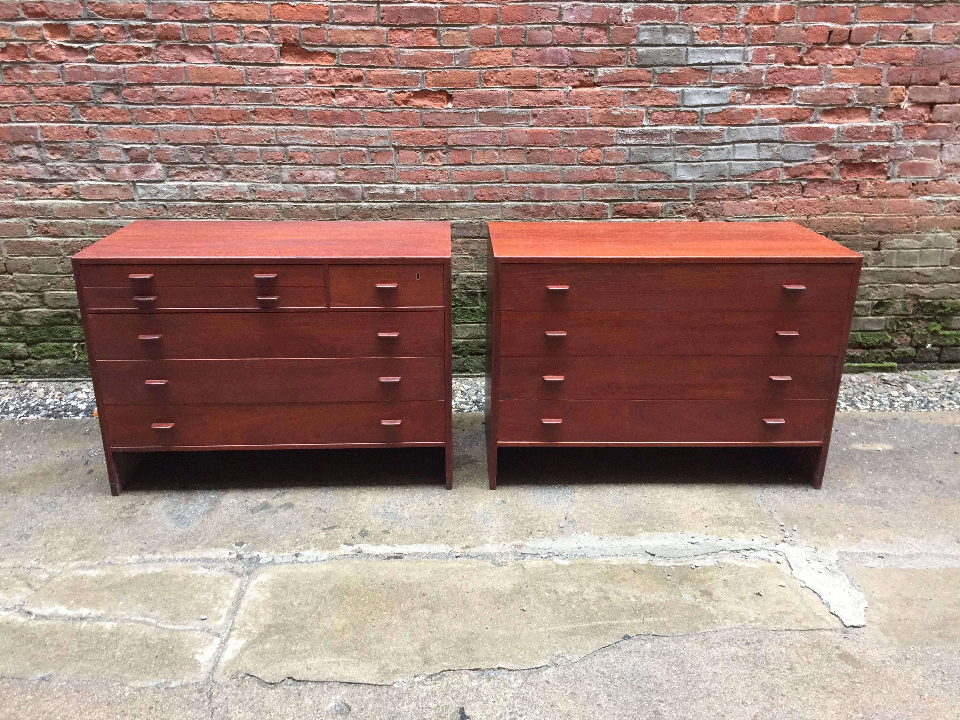 Beautiful pair of cabinets designed by Hans Wegner for Ry Mobler, Denmark. Teak veneer construction with solid teak handles. One cabinet contains six drawers with the two top drawers felt lined. It retains the original brass key, but it has been