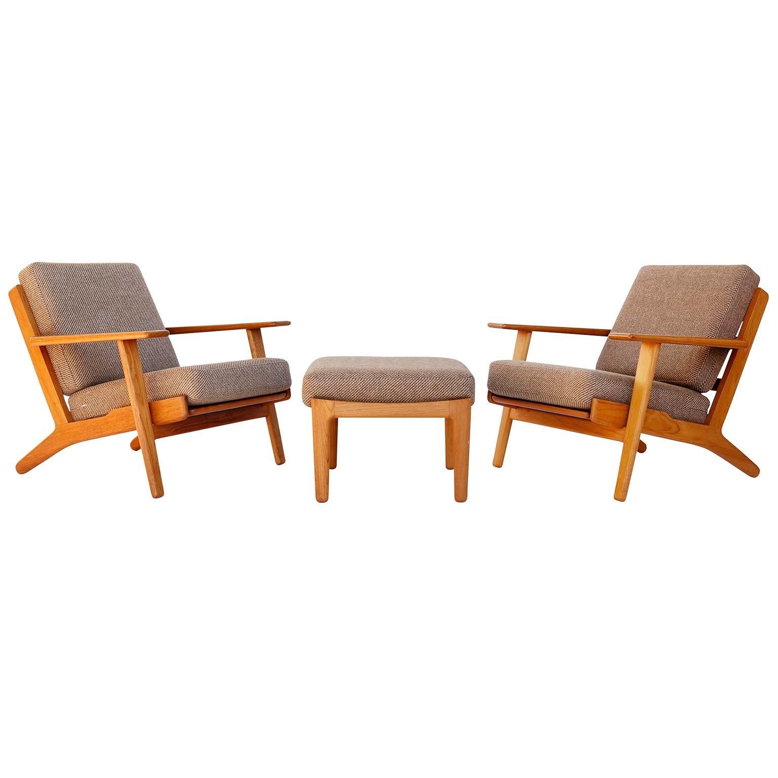 A pair of Danish modern easy chairs model GE-290 and ottoman designed by Hans Wegner for GETAMA, manufactured in midcentury in 1950s.
The armchairs are made of teak and loose cushions which are covered with a high quality fabric with brown and cream