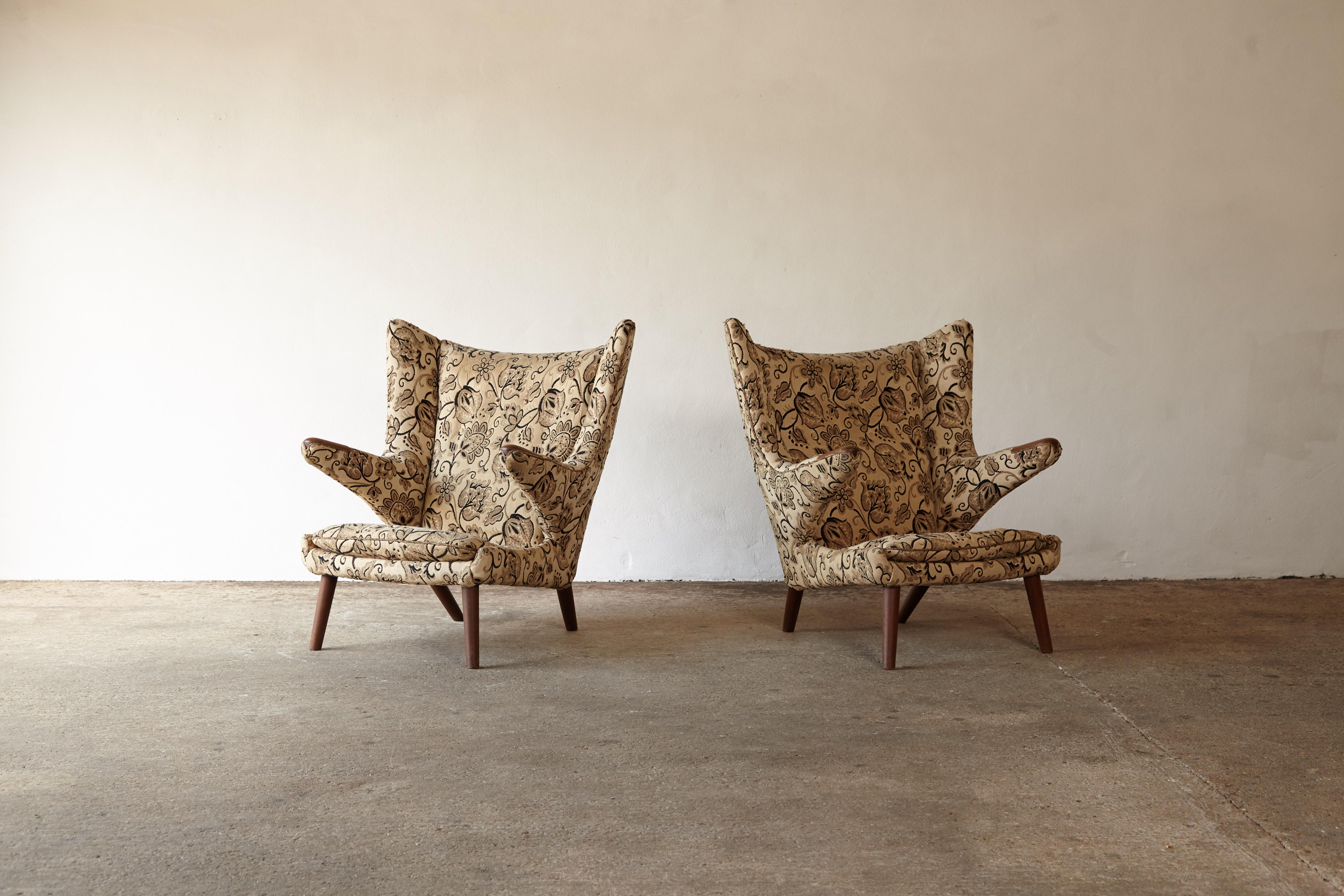 An original pair of Hans Wegner papa bear chairs designed in 1947 and produced by AP Stolen in Denmark in the 1950s. The fabric is damaged so these are offered in their current original condition for the customer to upholster in their own choice of