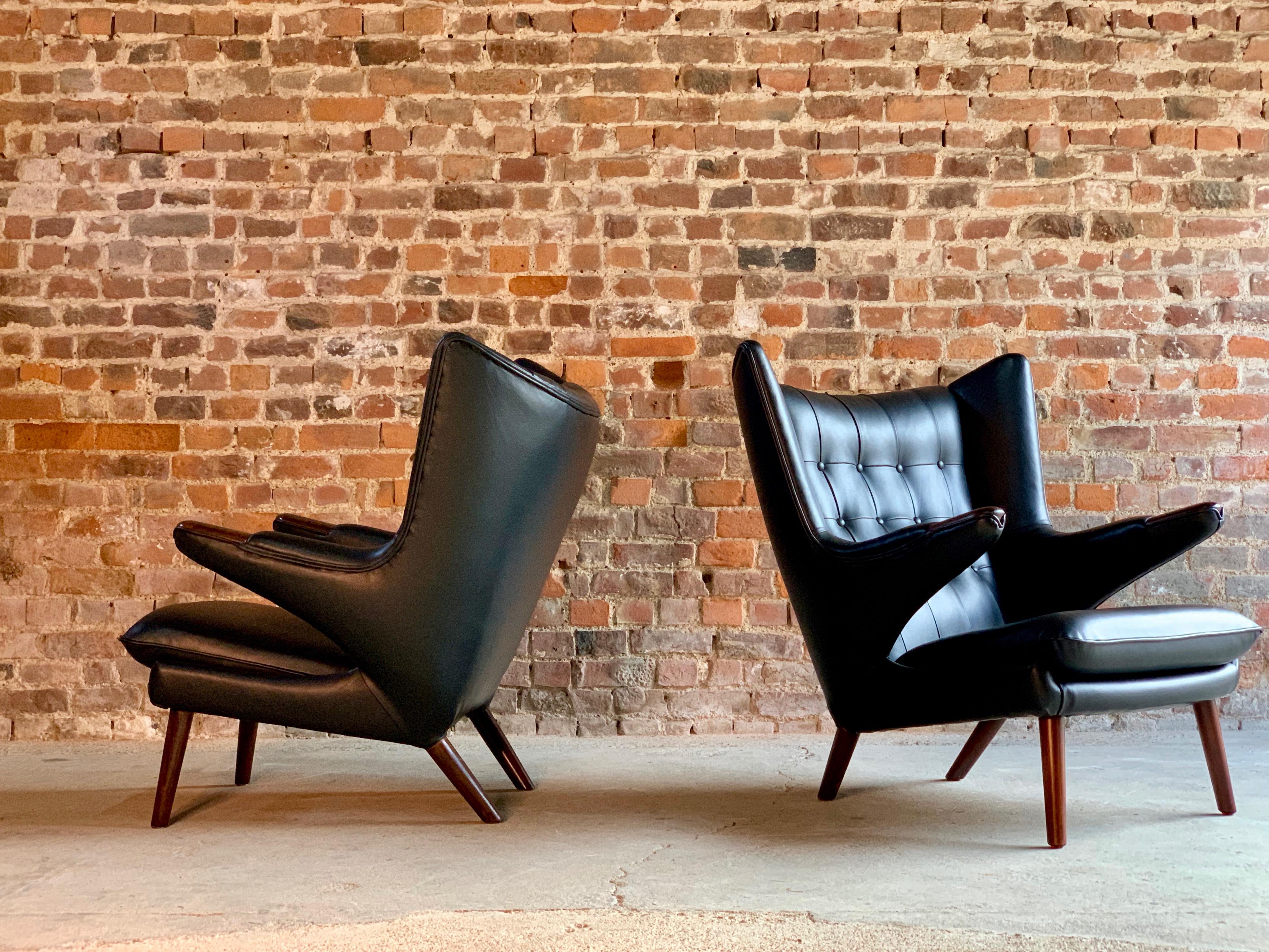 Pair of Hans Wegner papa bear lounge chairs black leather & Afromosia Model AP19, Denmark, 1963

?Hans J Wegner black leather 'Papa Bear' chair Model AP19, Denmark, 1963, otherwise known as a 'Bamsestol', designed in 1951, this example dates to