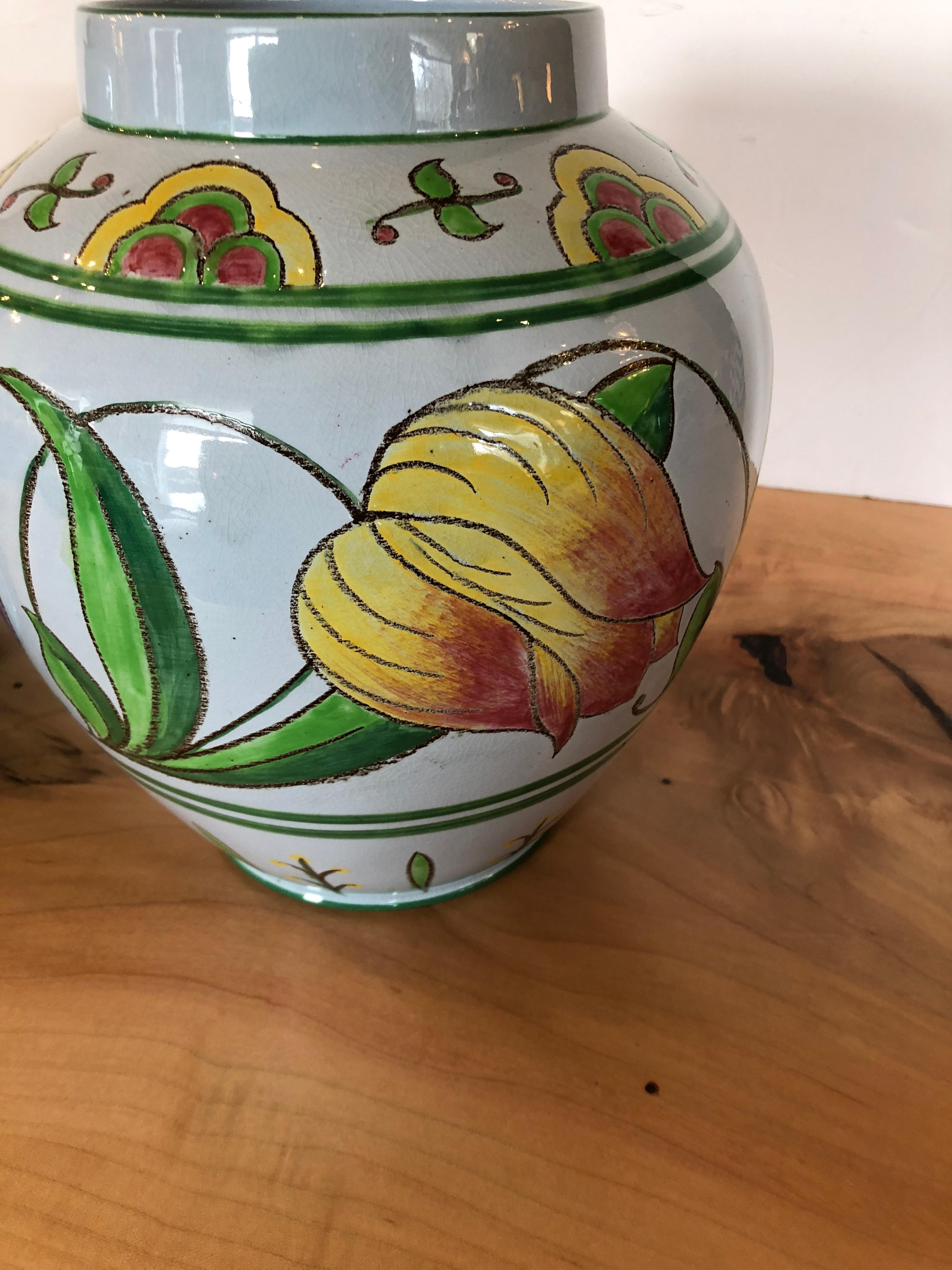 Two nice sized beautifully decorated flowerpots having yellow, raspberry, and green against a very pale grey background with happy stylized tulips adorning them. Stamped Made in England on the bottom.