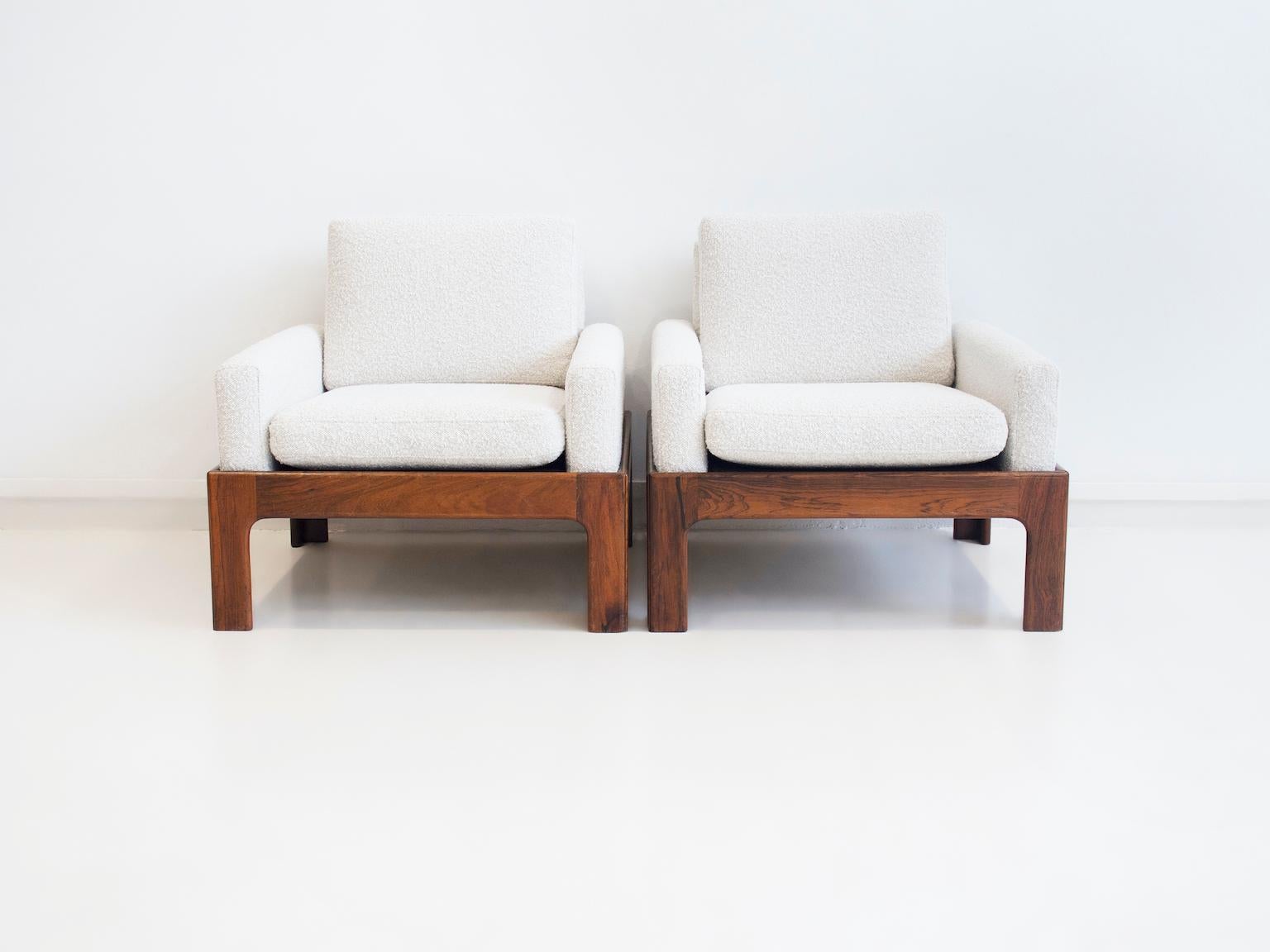 Pair of lounge chairs attributed to Illum Wikkelsø. Made of solid hardwood and recently reupholstered in white bouclé fabric. Produced by Eilersen.