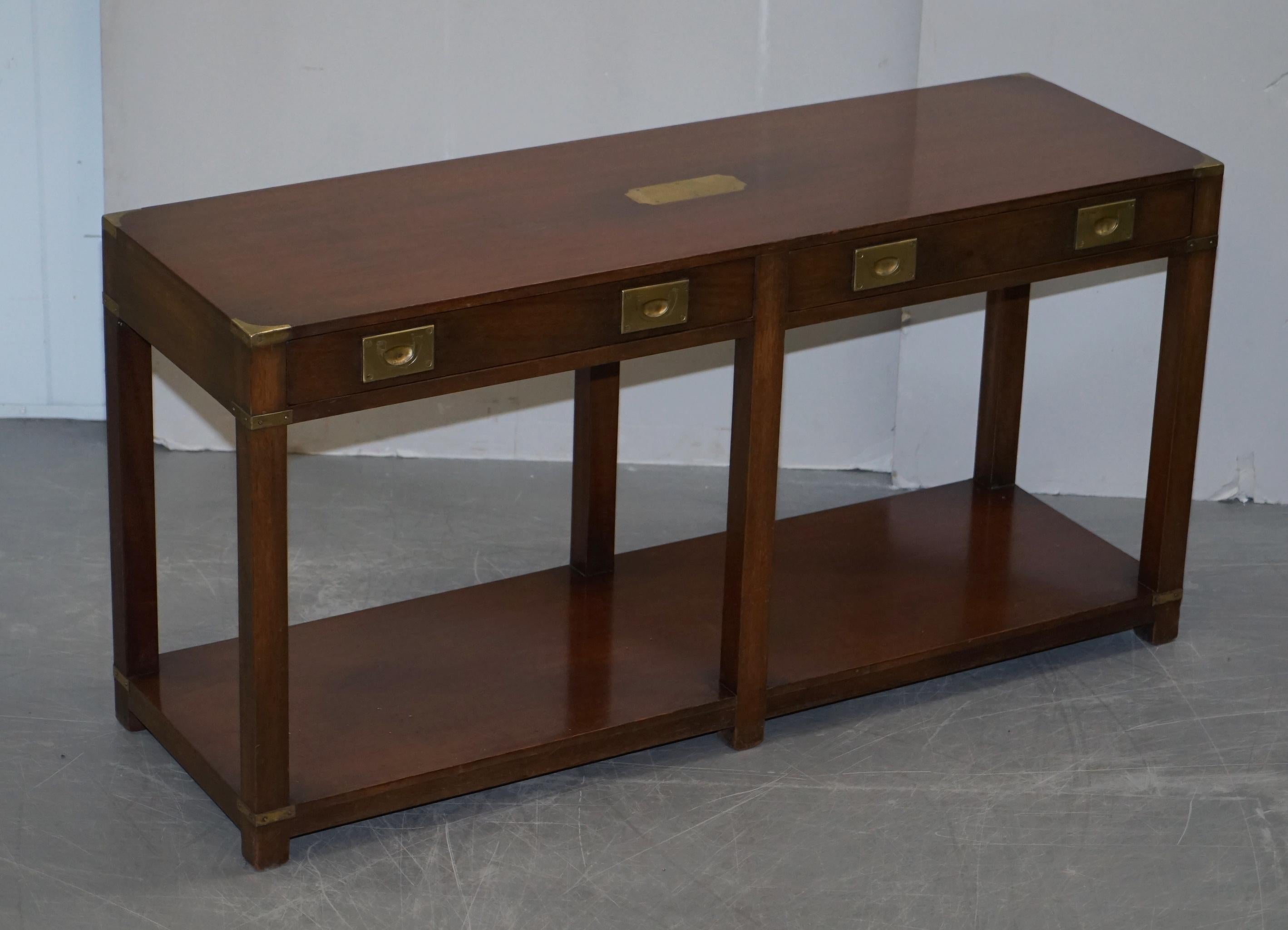We are delighted to offer for sale this lovely pair of vintage Harrods London Kennedy Furniture Military Campaign console tables with twin drawers 

These were made by Kennedy Furniture who were Harrods oldest concession, they retailed with them