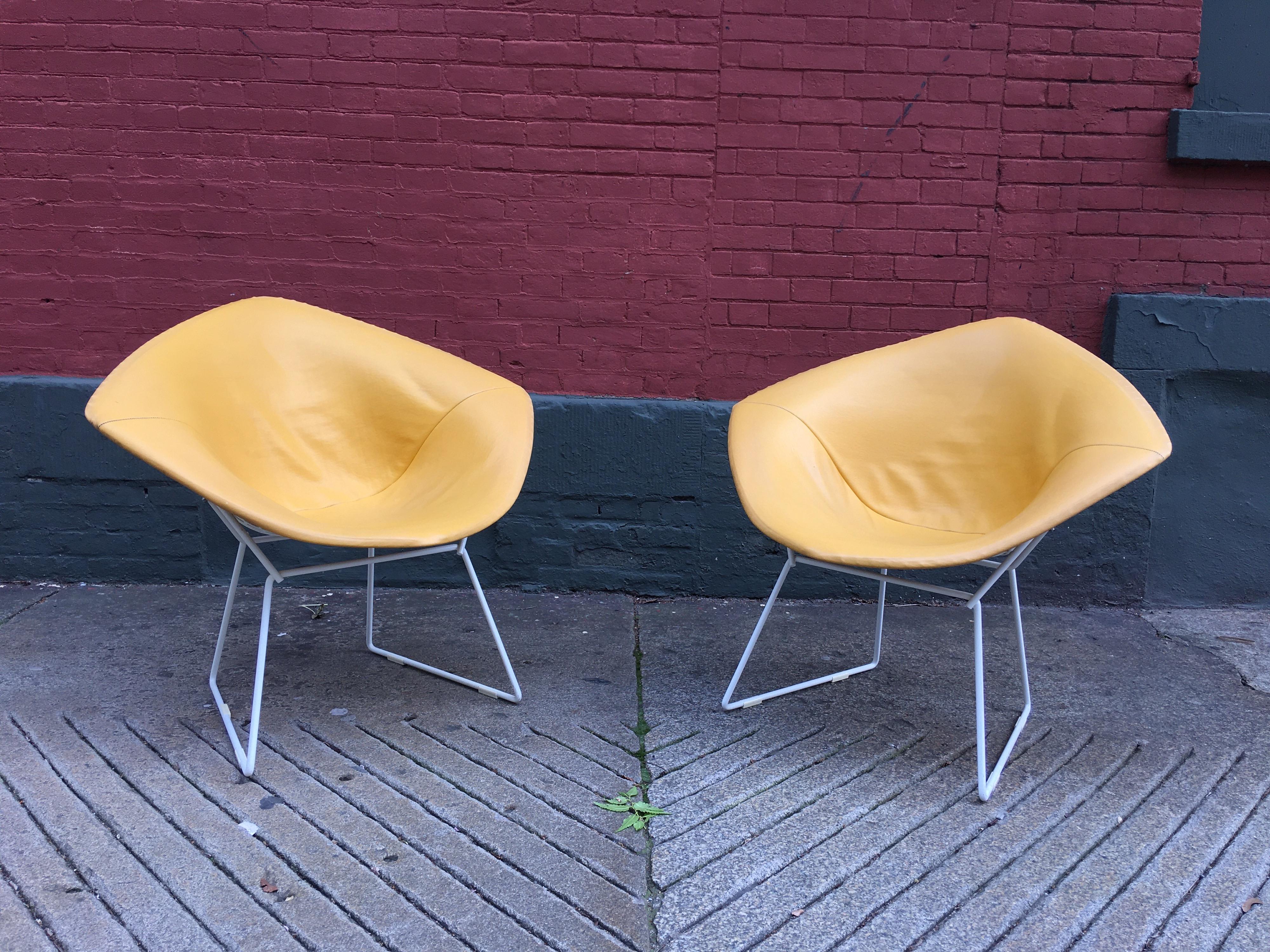 Nice early pair of Harry Bertoia for Knoll diamond chairs. Very early label, these chairs date to the early 1960s mustard colored yellow seat pads in very nice condition! White frames are near perfect! Always inside these chairs are very clean. One