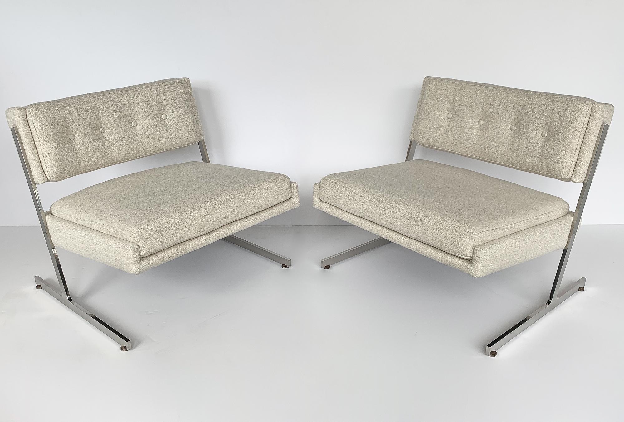 Pair of Harvey Probber cantilevered armless slipper lounge chairs, circa 1960s. Newly upholstered in a sophisticated textured woven off white fabric. New foam throughout. Semi-attached seat cushion and back rest with button detail. Polished steel