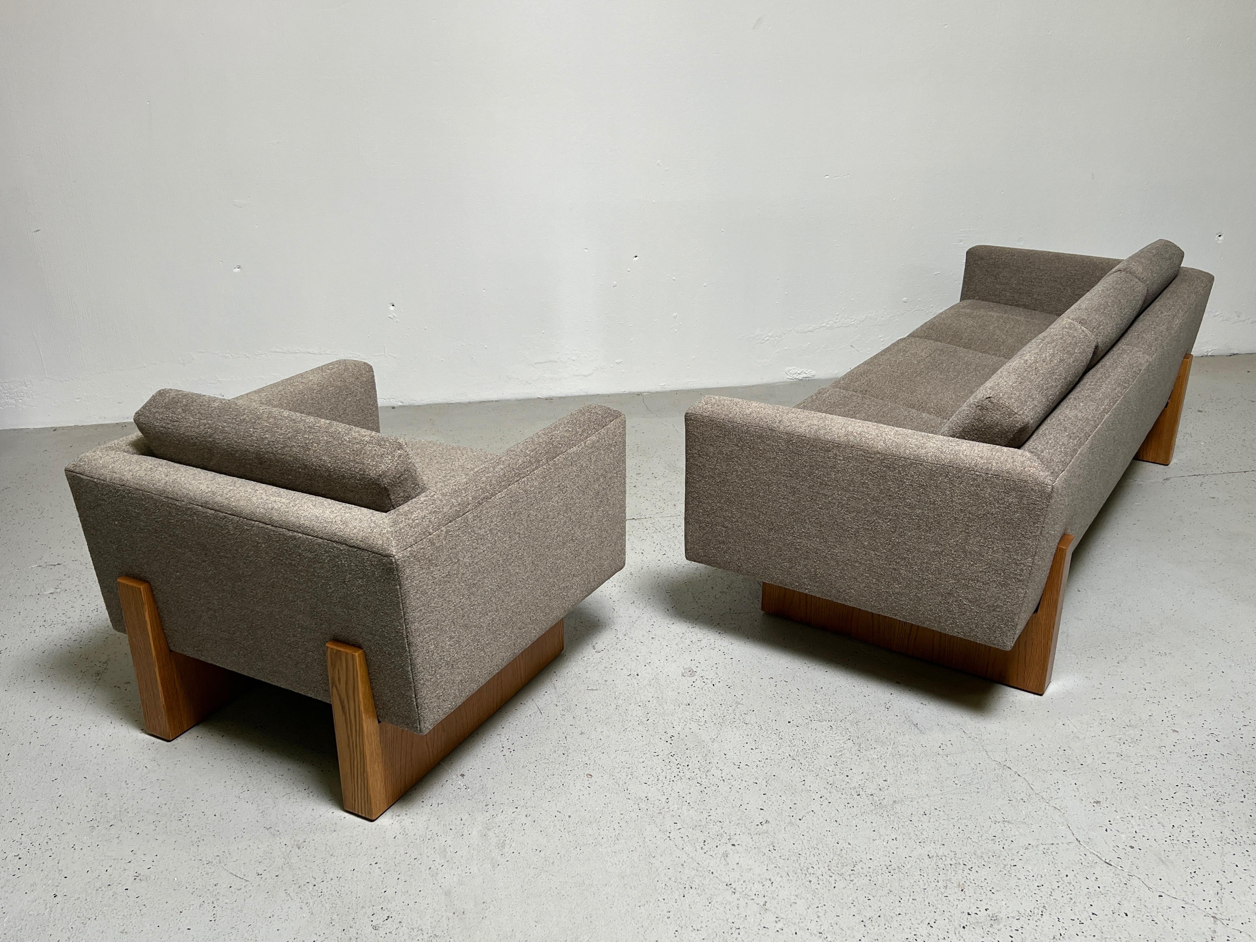 A pair of Harvey Probber club chairs on oak bases. Matching sofa also available. Fully restored with refinished bases and new upholstery.