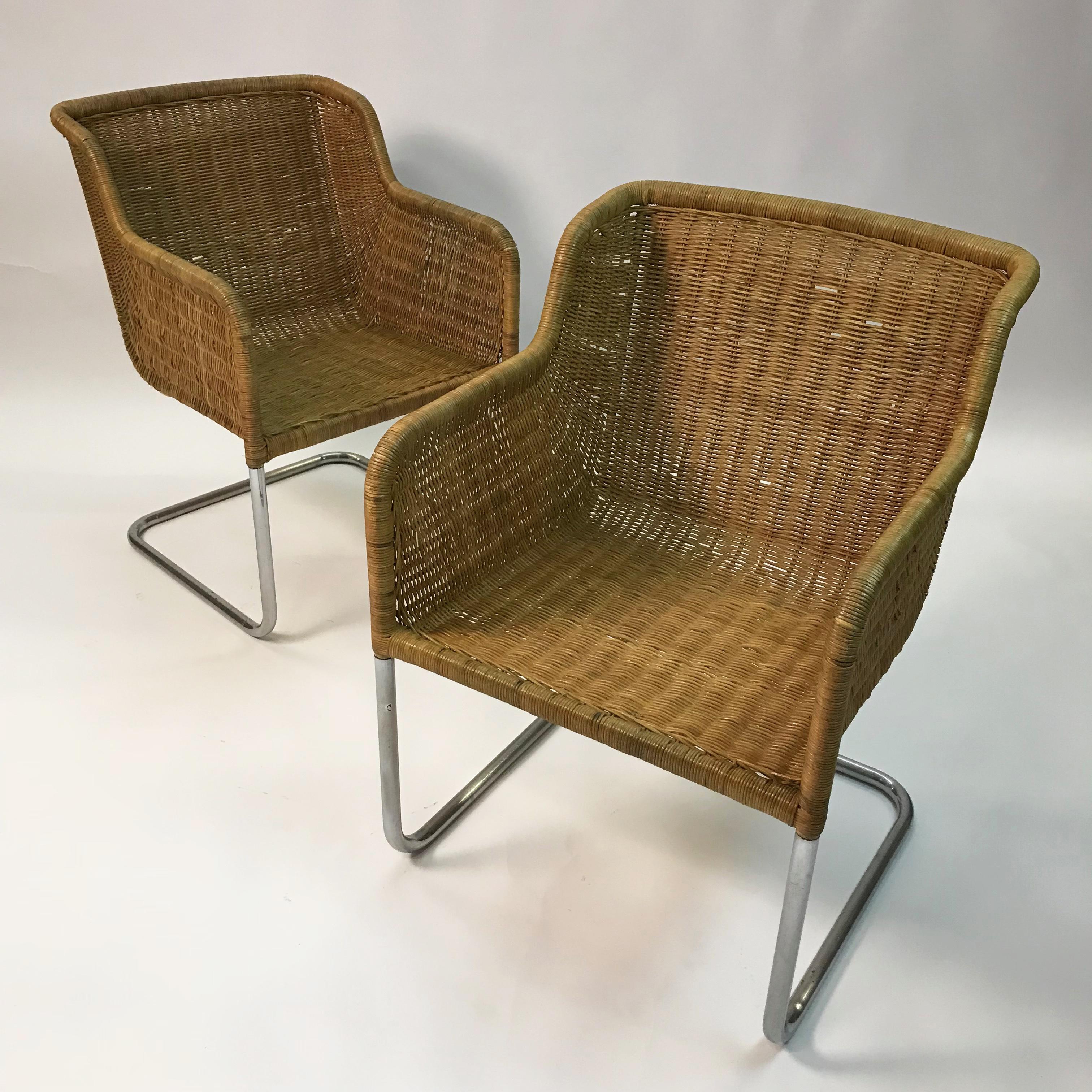 Mid-Century Modern, armchairs in the style of Harvey Probber feature deep, bucket, rattan wicker seats with cantilever, chrome bases. Measures: Arm height is 27 inches and seat depth is 18 inches. Listed price is for the pair.