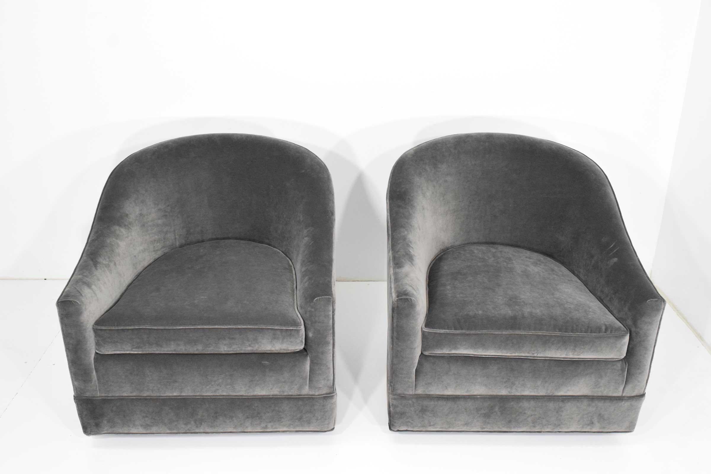 Chairs are upholstered in a gray velvet. They swivel and have a black base. They are super comfortable and a good size.