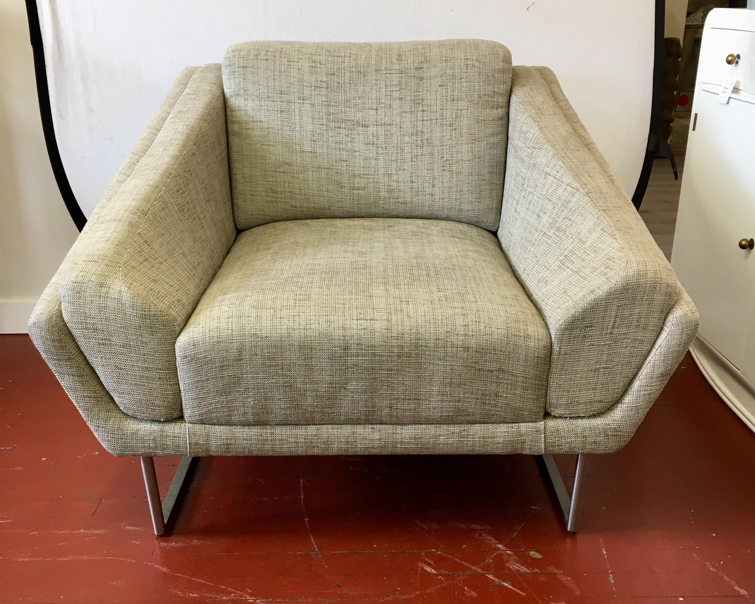 Mint condition, pair of curved lounge chairs by HBF Hickory, N.C.. The upholstery is a medium gray cotton weave and in perfect condition. The base or legs are a polished chrome. HBF is affiliated with Barbara Barry and they design and manufacture