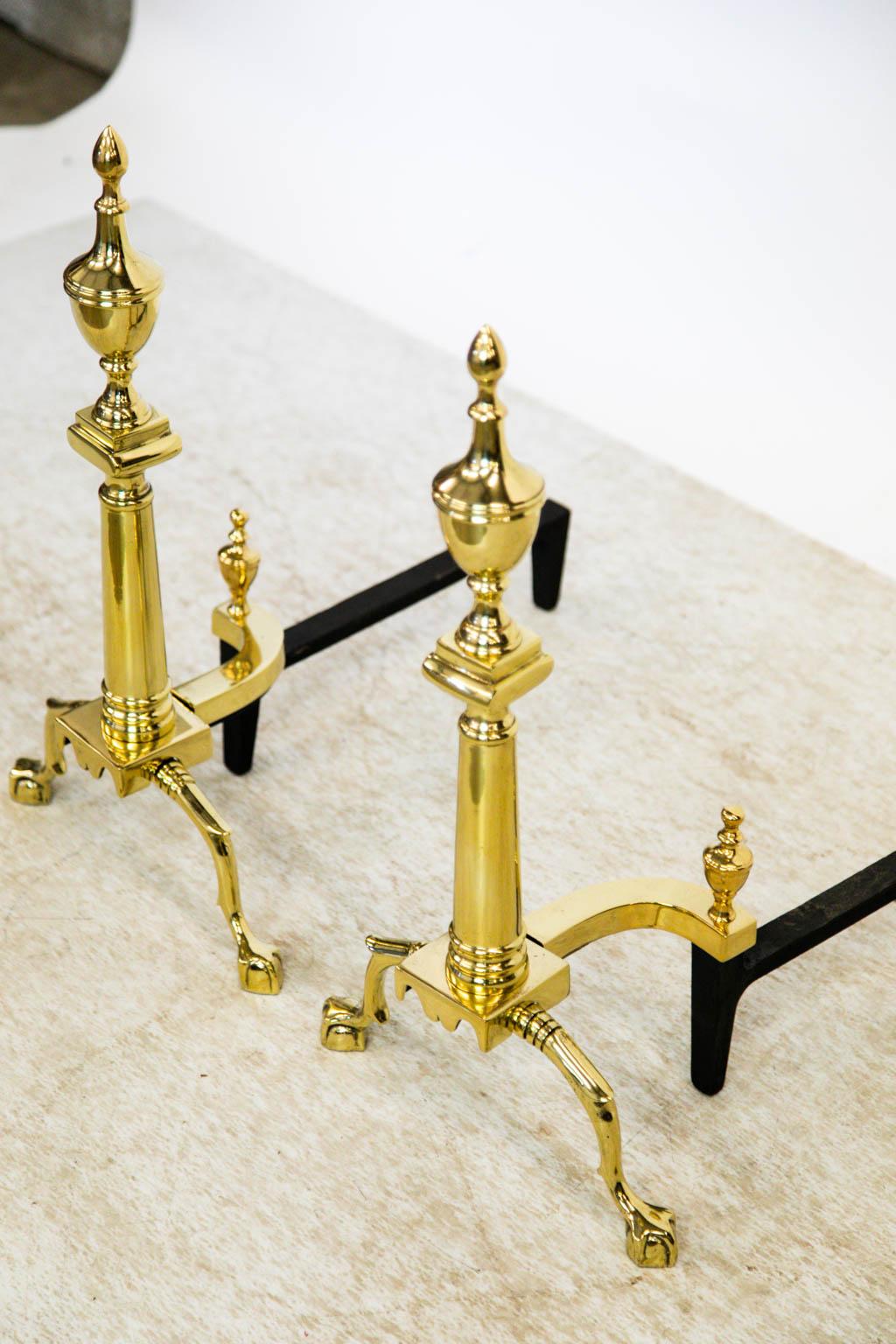 These American andirons have been polished and lacquered for ease of maintenance. The steel supports have been painted black.