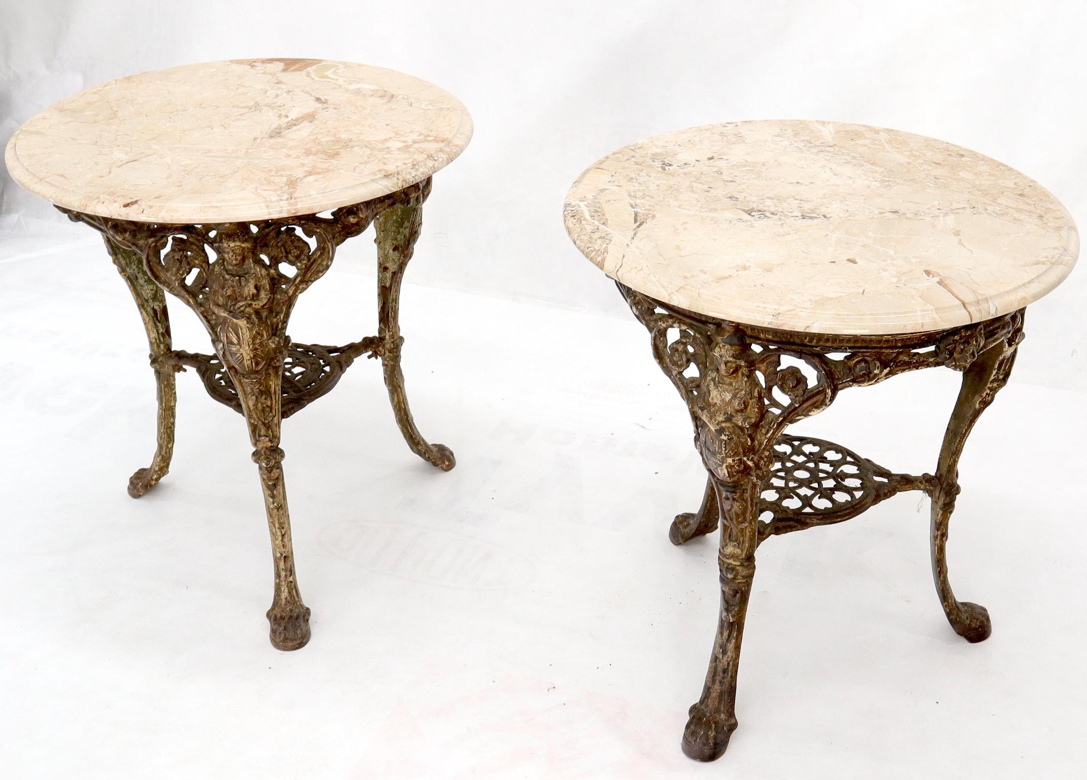 Pair of heavy cast iron bases marble tops round guéridon cafe stands lamp tables.