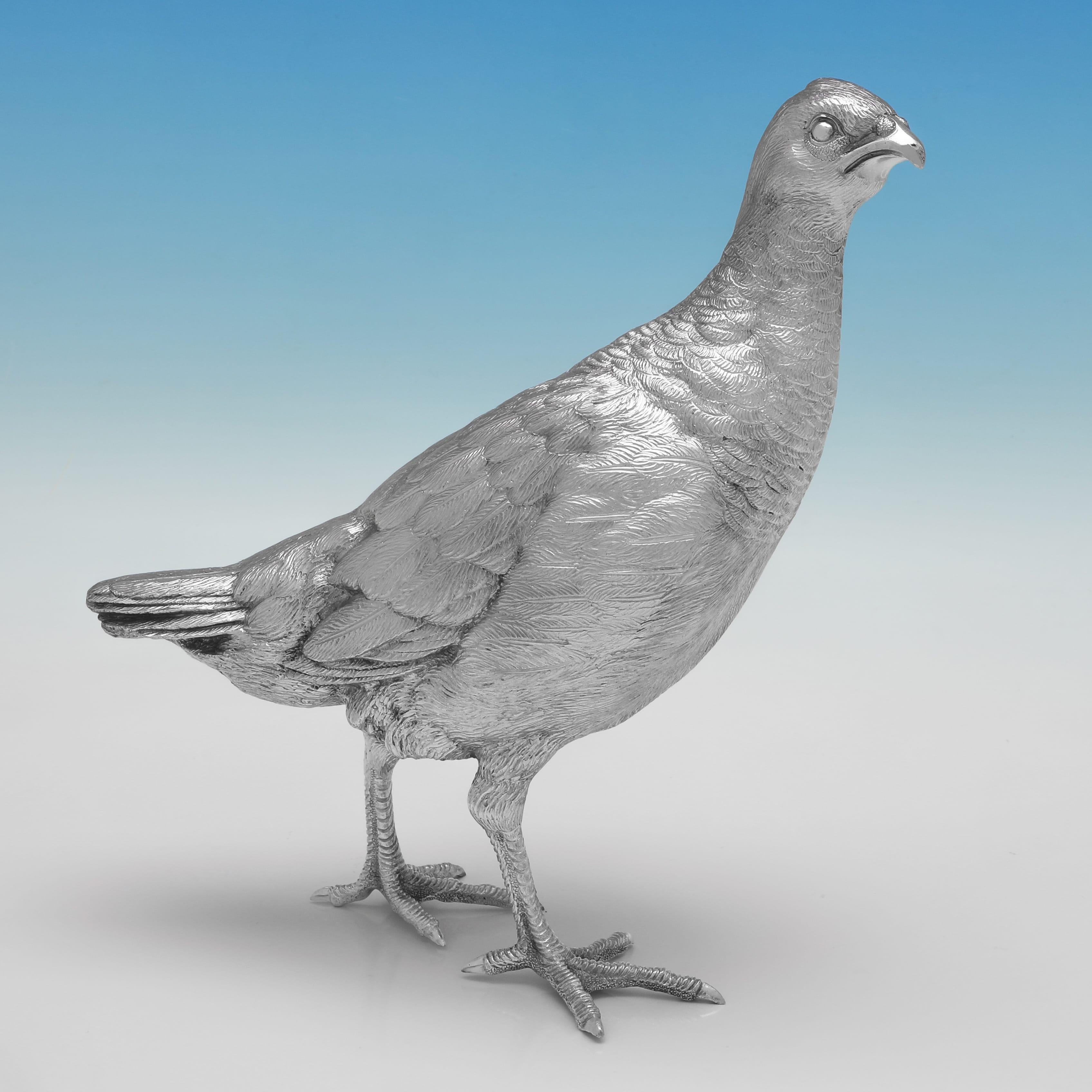Hallmarked in Sheffield in 1999 by C. J. Vander, this charming pair of Elizabeth II, Sterling Silver Partridges, are handsomely cast and hand finished. The pair together weigh a substantial 80.84 troy ounces.
 
Bird one measures 8.75