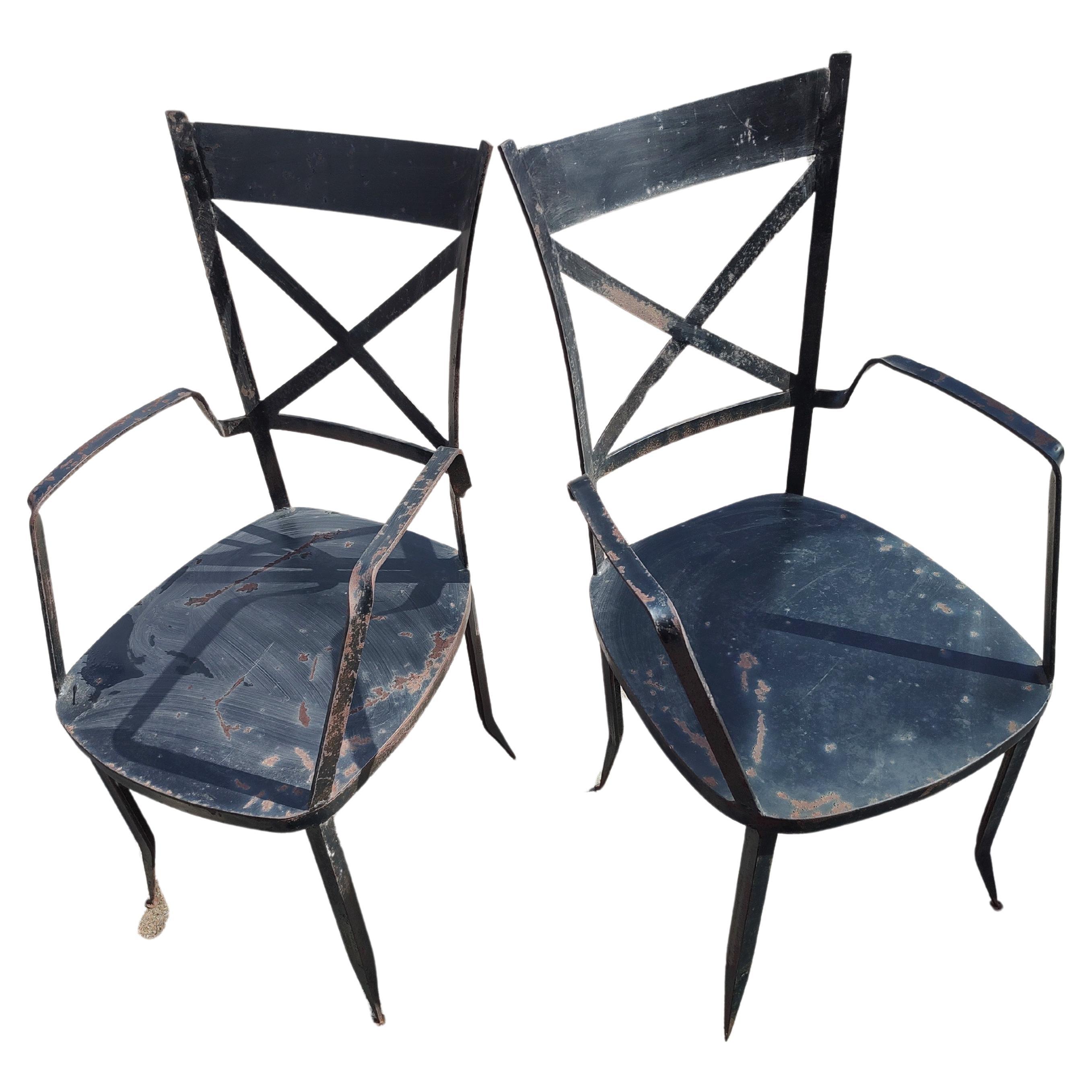Fabulous pair of angular modern garden patio dining armchairs. High quality hand made in raw iron and steel. Chairs are very heavy and have lots of patina from living outside. Structurally as sound as could be. Minimalist design with a classic touch