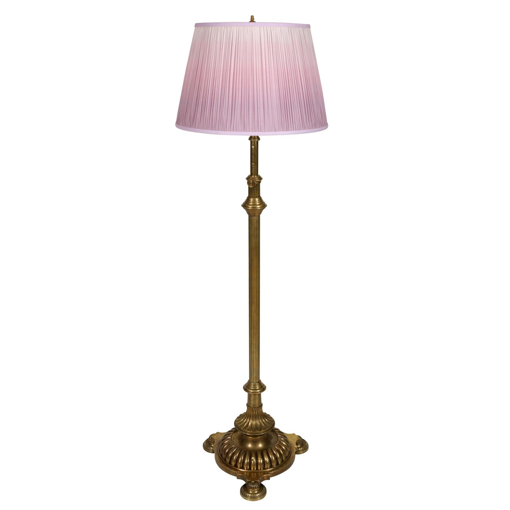 A pair of heavy brass English telescoping fluted floor lamps with round base on three feet. Shades sold separately.
