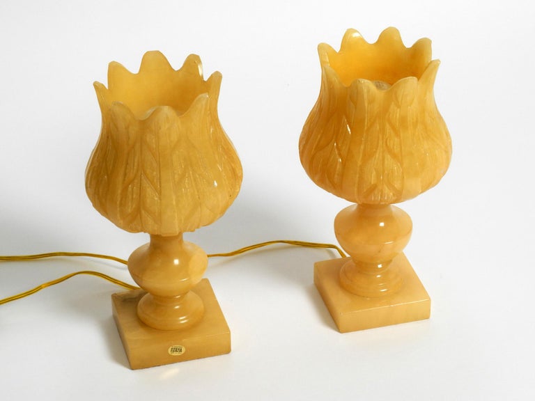 Pair of beautiful rare 1960s yellow alabaster table lamps. Great vintage design. 
Manufacturer is HERNA. Made in Spain. 
Elaborately processed yellow albaster with a great grain.
Makes a great warm light.
Lamps are made entirely of albaster,