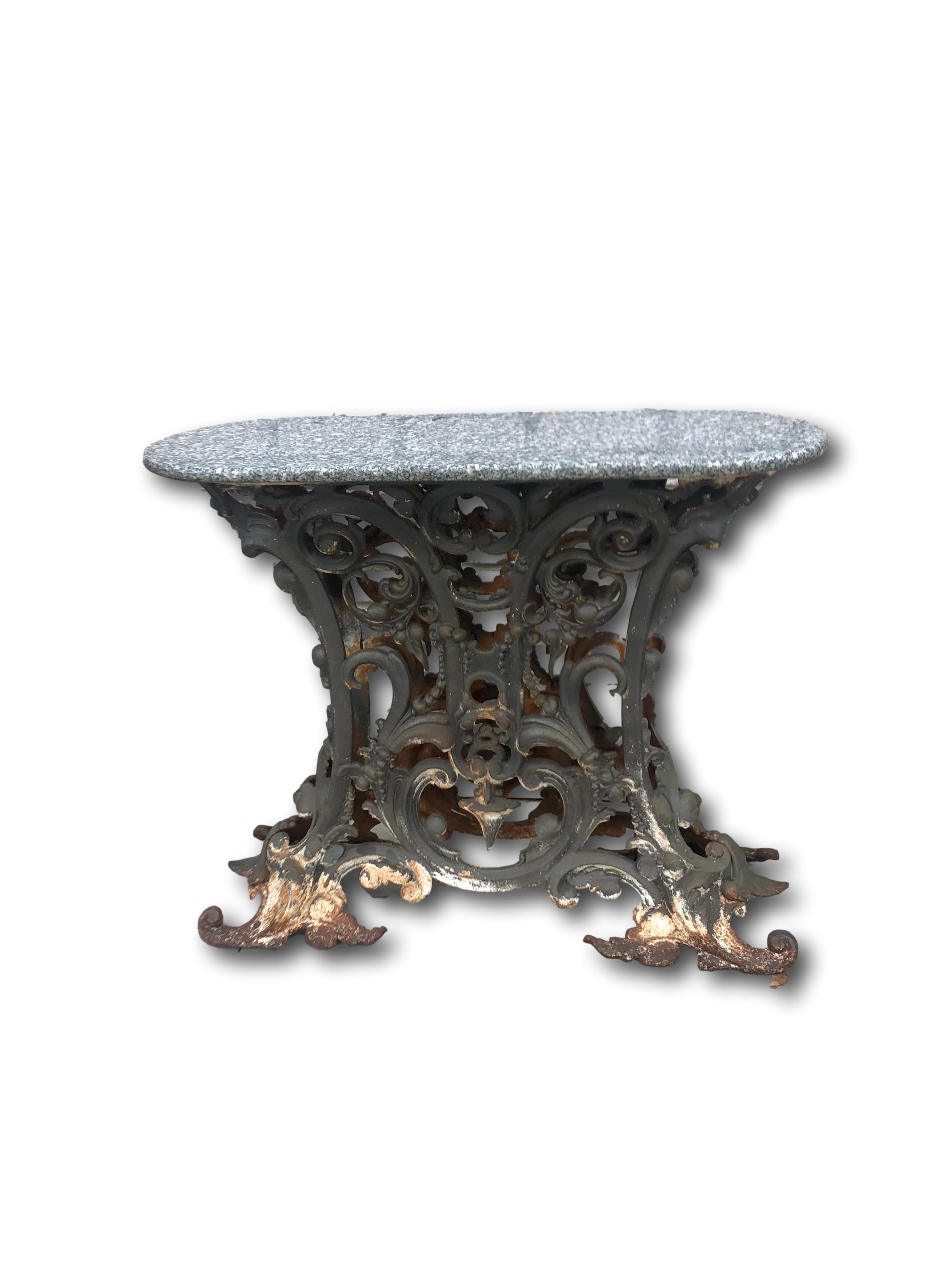 Pair of French console tables from the late 19th century with a wrought iron oval-shaped frame and removable grey granite surface. The two-sided heavy wrought iron frame features C-scrolls, fruit and acanthus leaves decoration. The console tables